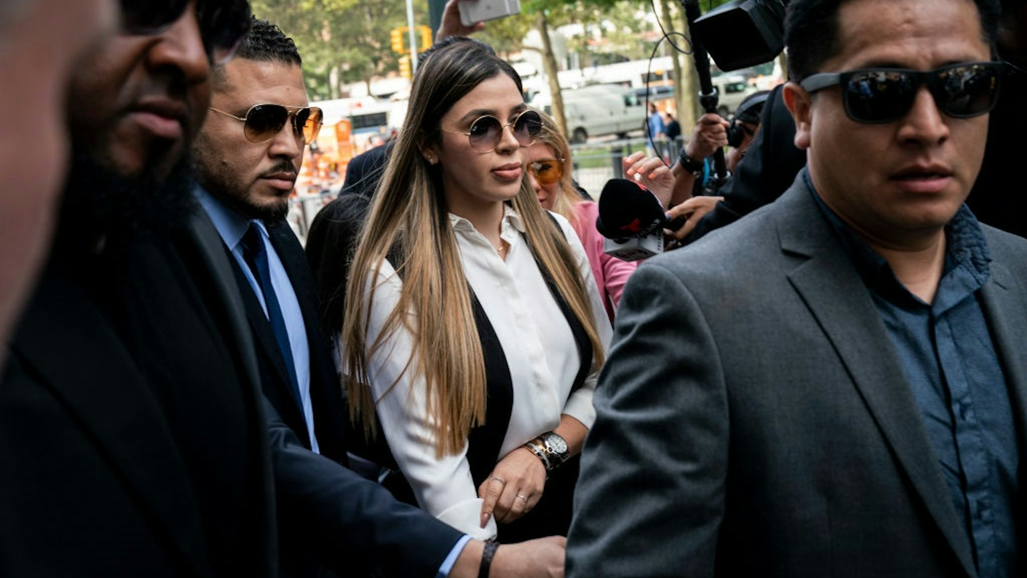 NEW YORK, NY - JULY 17: Emma Coronel Aispuro, wife of Joaquin "El Chapo" Guzman, is surrounded by security as she arrives at federal court on July 17, 2019 in New York City.