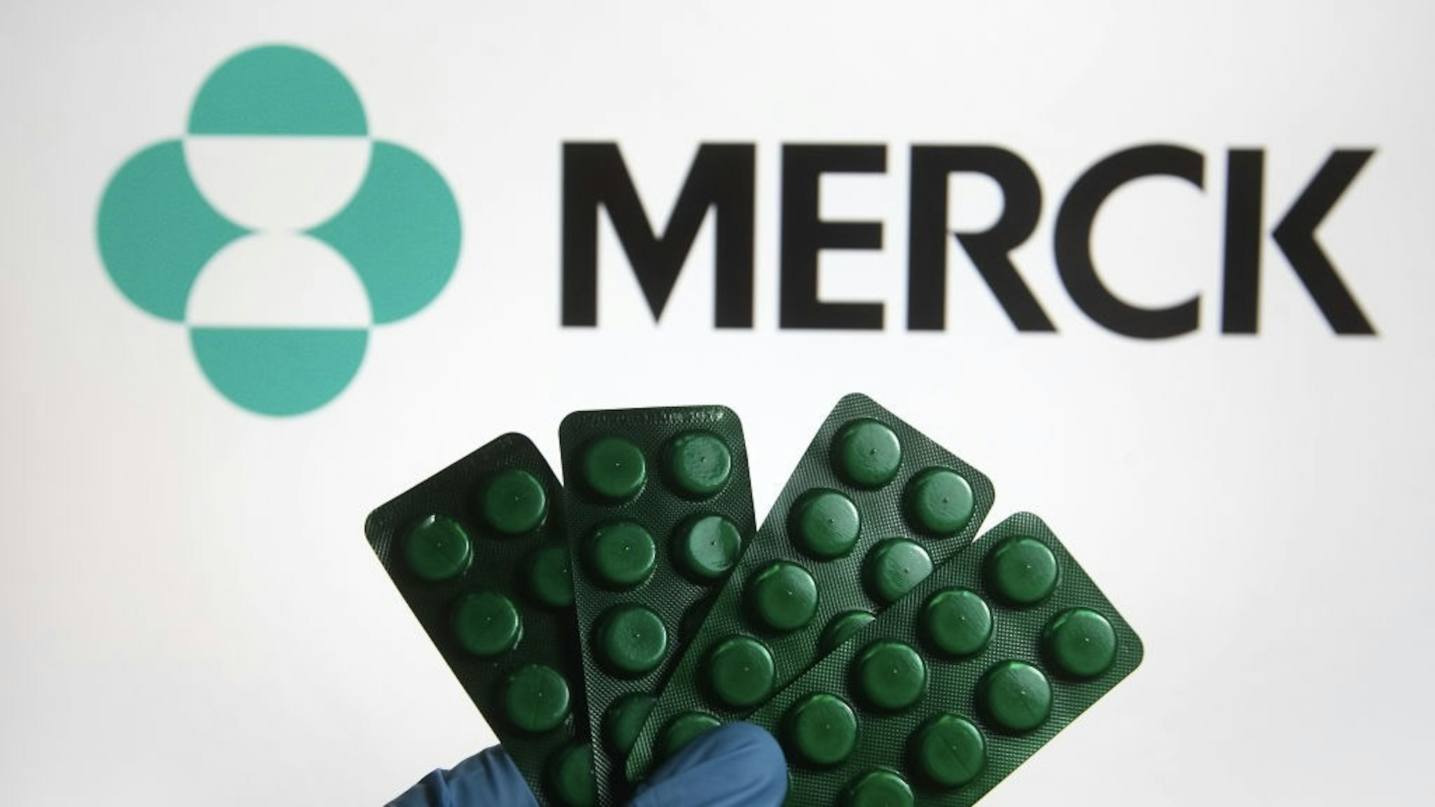 In this photo illustration, medicine pills are seen on... UKRAINE - 2021/10/17: In this photo illustration, medicine pills are seen on display with a Merck & Co., Inc. logo of the pharmaceutical company in the background. (Photo Illustration by Pavlo Gonchar/SOPA Images/LightRocket via Getty Images) SOPA Images / Contributor