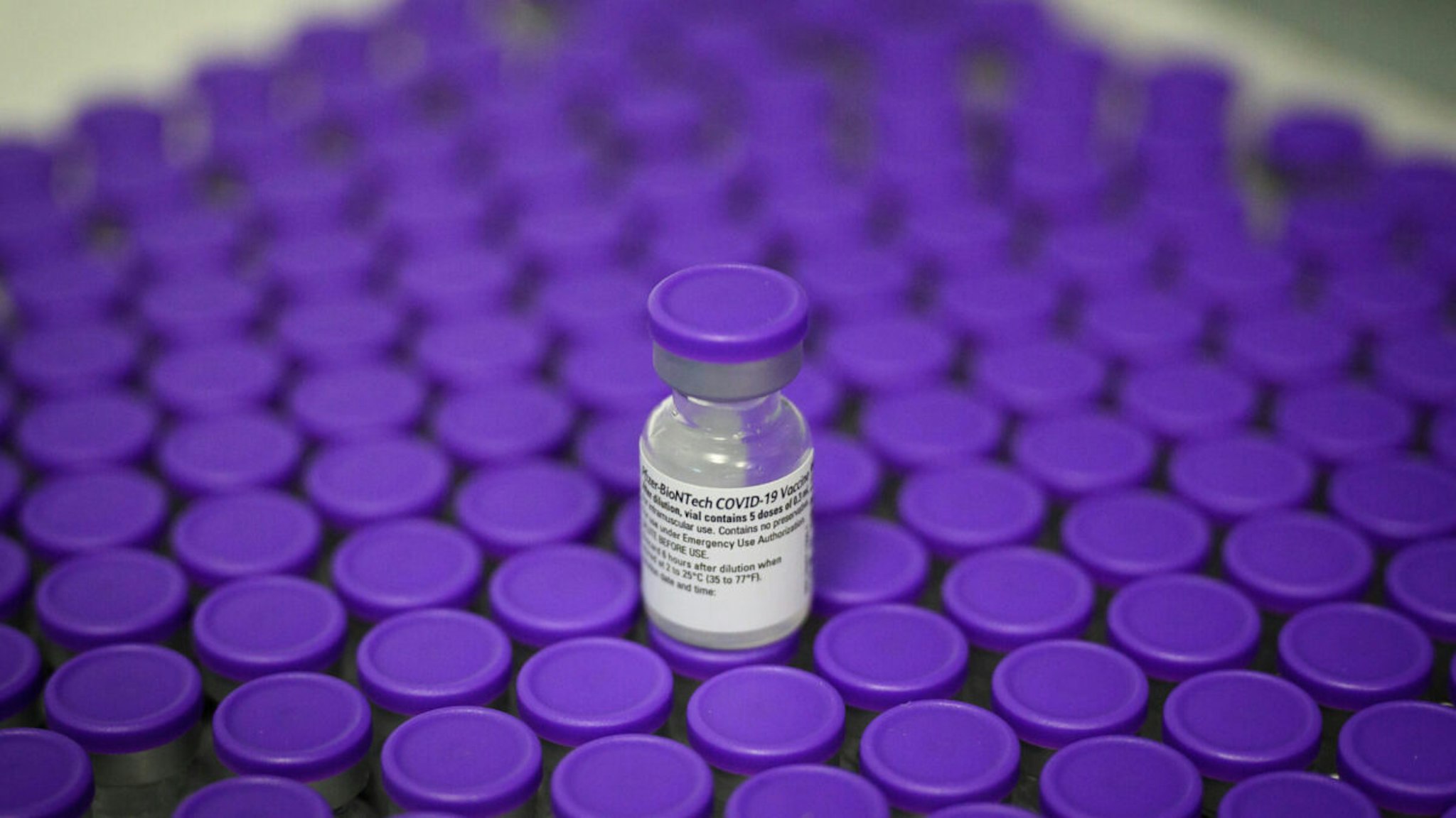 Vials of the Pfizer/BioNTech Covid-19 vaccine are seen during a vaccination clinic at the Sir Ludwig Guttmann Health and Wellbeing Centre on December 15, 2020 in Stratford, England.