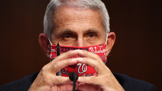 Anthony Fauci, director of the National Institute of Allergy and Infectious Diseases, wears a Washington Nationals protective mask during a Senate Health, Education, Labor and Pensions Committee hearing in Washington, D.C., U.S., on Tuesday, June 30, 2020. Top federal health officials are expected to discuss efforts to get back to work and school during the coronavirus pandemic.