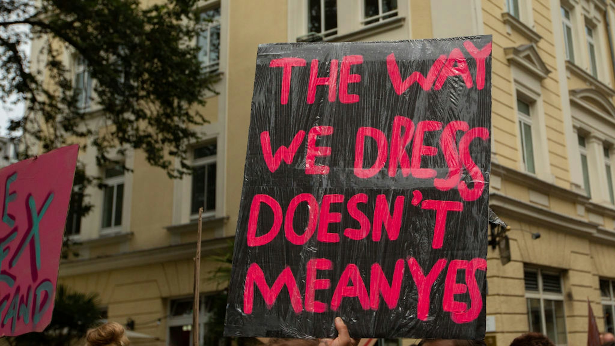 Protestor holds sign saying 'The way we dress doesn't mean yes'. Some 500 people demonstrated through the streets of Munich, Germany, on 21 July 2018 to protest against sexism, rape and sexual harassment. The Slut Walk is a yearly held demonstration all over the world protesting against slut blaming and victim blaming. (Photo by Alexander Pohl/NurPhoto via Getty Images)