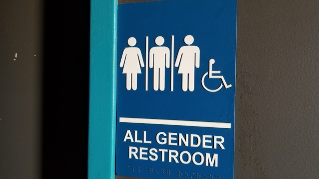 Close-up of sign for all gender restroom in Dublin, California, with male, female and gender-inclusive stick figure illustrations, March 13, 2019. (Photo by Smith Collection/Gado/Getty Images)
