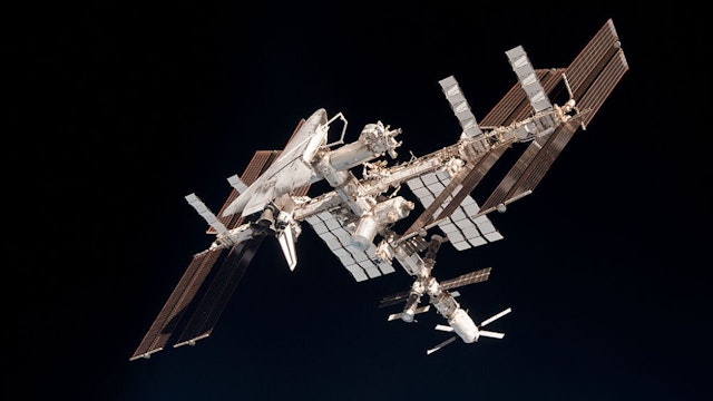 IN SPACE - MAY 23: In this handout image provided by the European Space Agency (ESA) and NASA, the International Space Station and the docked space shuttle Endeavour orbit Earth during Endeavour's final sortie on May 23, 2011 in Space. Italian astronaut Paolo Nespoli captured the first-ever images of an orbiter docked to the International Space Station from the viewpoint of a departing vessel as he returned to Earth in a Soyuz capsule.