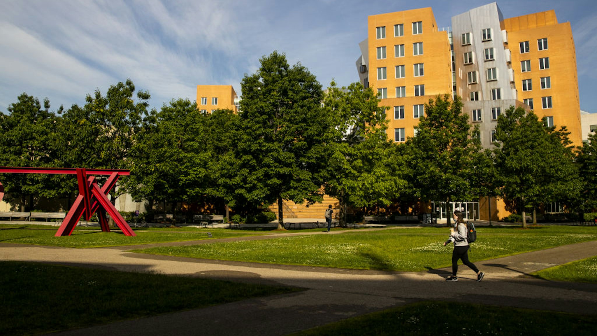 A student walks through Hockfield Court at the Massachusetts Institute of Technology (MIT) campus in Cambridge, Massachusetts, U.S., on Wednesday, June 2, 2021.
