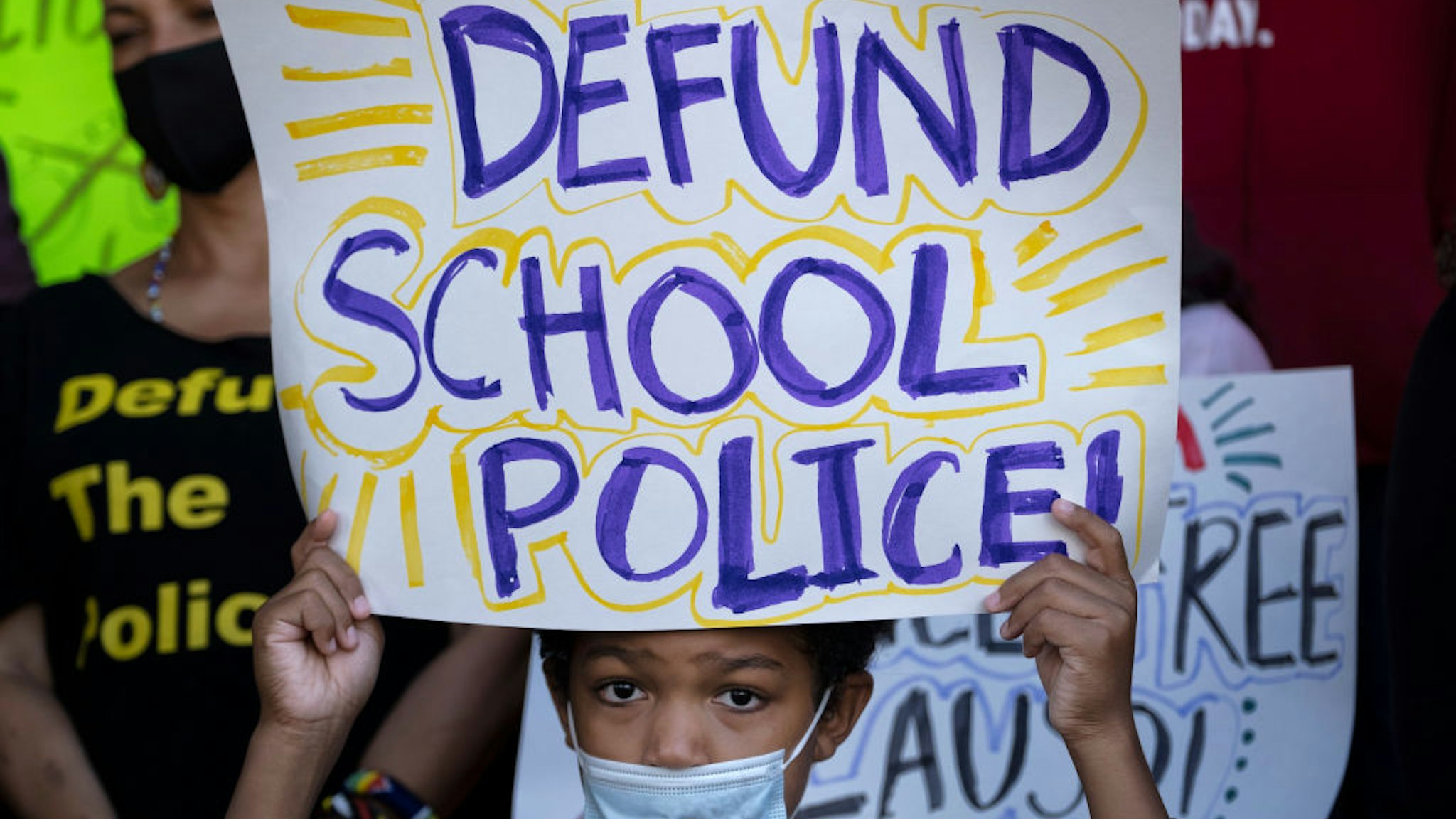 Los Angeles, CA - June 03: Channing Flagg, 9-years old, holds a sign during a news conference. Students Deserve coalition members hold a news conference and rally outside the Los Angeles Unified School District office in Los Angeles to call on the school board to completely defund and eliminate the Los Angeles School Police Department, Thursday, June 3, 2021. (Photo by Hans Gutknecht/MediaNews Group/Los Angeles Daily News via Getty Images)