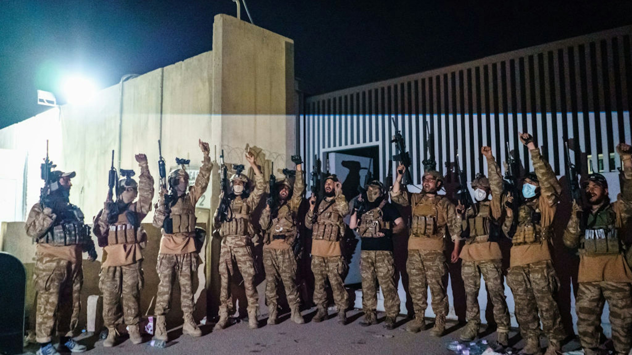Taliban fighters from the Fateh Zwak unit celebrate before storming into the Kabul International Airport, wielding American supplied weapons, equipment and uniforms after the United States Military have completed their withdrawal, in Kabul, Afghanistan, Tuesday, Aug. 31, 2021.