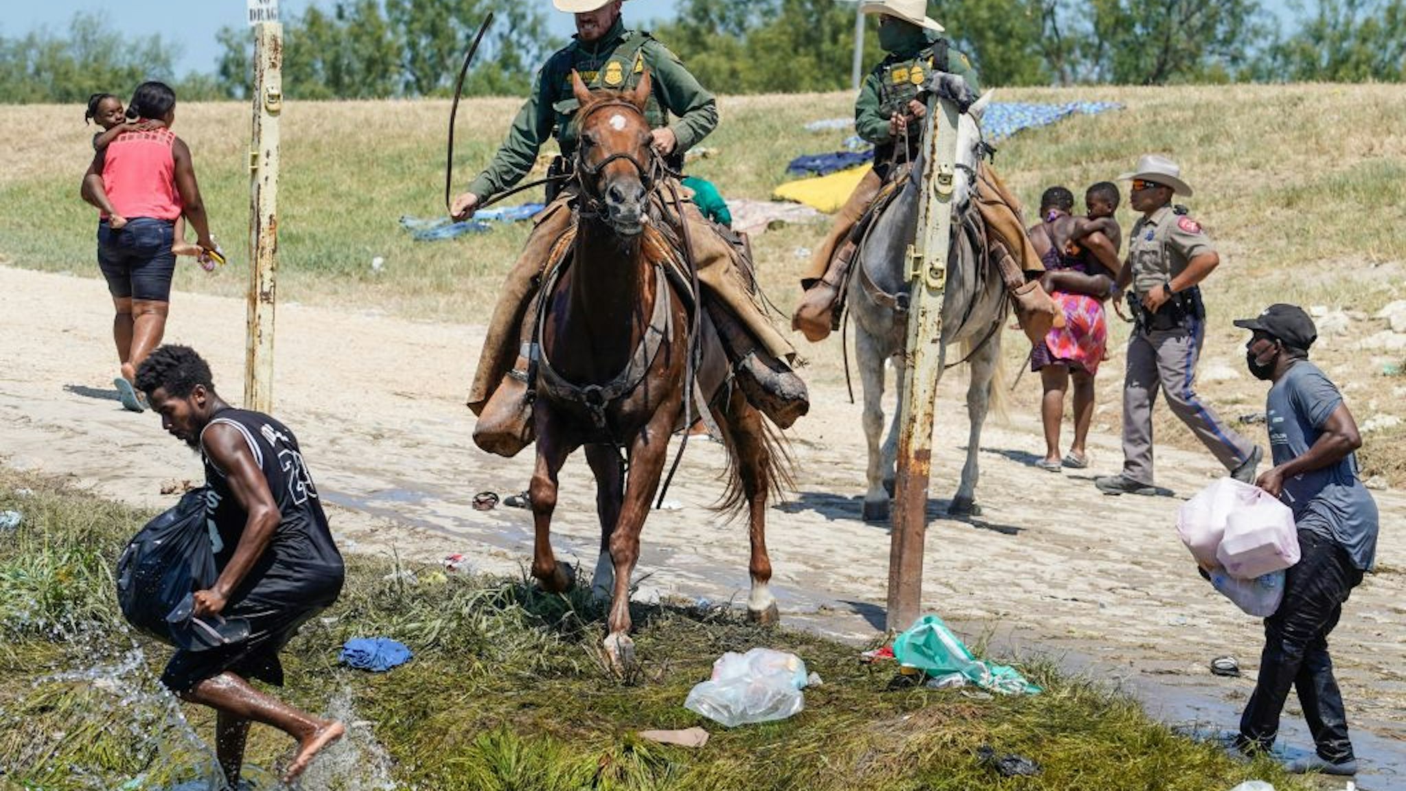 United States Border Patrol agents on horseback try to stop Haitian migrants from entering an encampment on the banks of the Rio Grande near the Acuna Del Rio International Bridge in Del Rio, Texas on September 19, 2021.