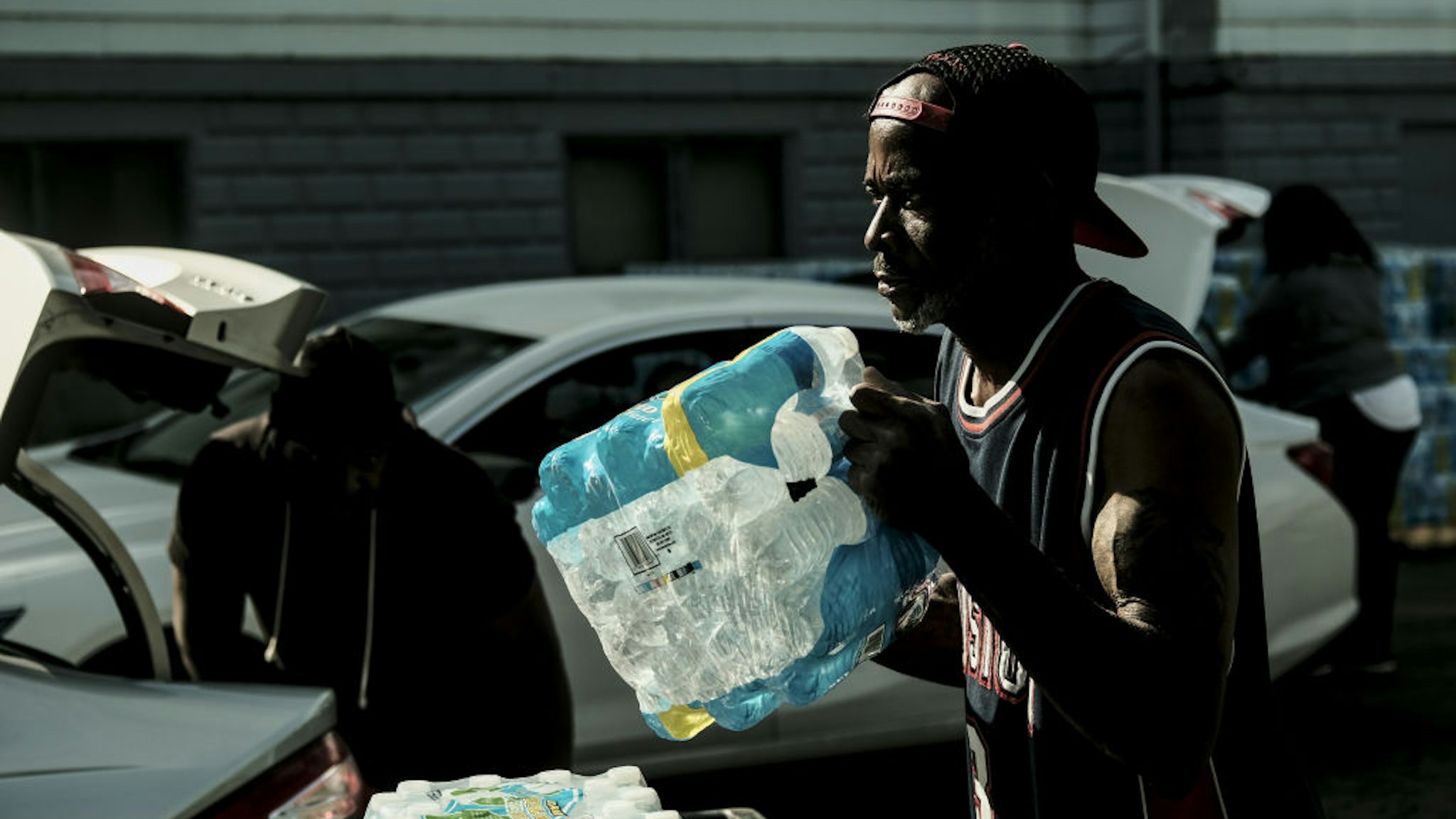 A volunteer distributes bottled water to residents at the Abundant Life Church of God in Benton Harbor, Michigan, U.S., on Tuesday, Oct. 19, 2021. Governor Gretchen Whitmer ordered a whole-of-government response to elevated levels of lead in tap water in the southwestern Michigan city of Benton Harbor and vowed to accelerate the replacement of its lead pipes, reported the Associated Press. Photographer: Matthew Hatcher/Bloomberg via Getty Images