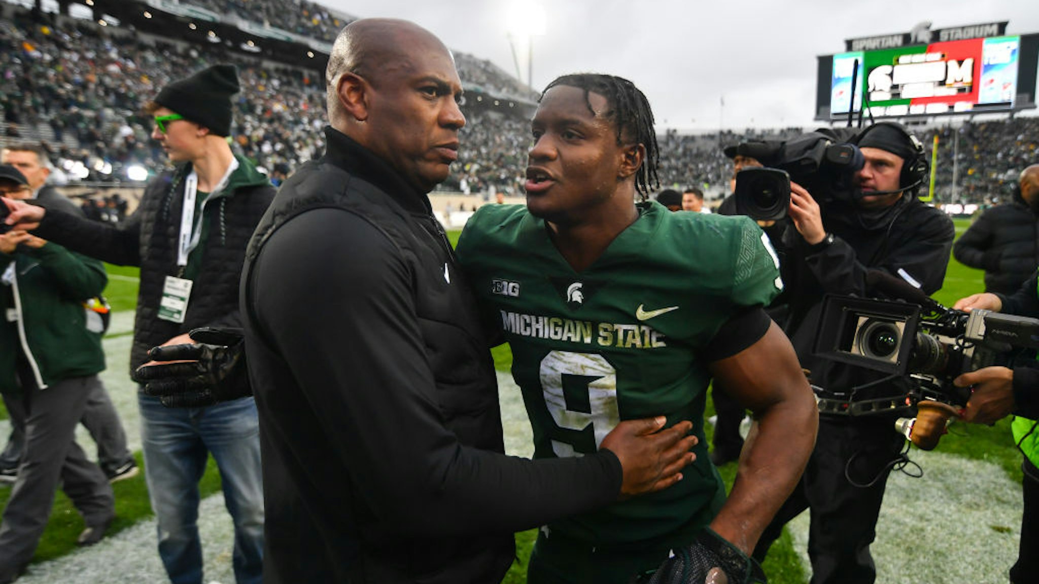 EAST LANSING, MI - OCTOBER 30: Michigan State Spartans head coach Mel Tucker congratulates running back Kenneth Walker III (9) following a college football game between the Michigan State Spartans and the Michigan Wolverines on October 30, 2021 at Spartan Stadium in East Lansing, MI. (Photo by Adam Ruff/Icon Sportswire via Getty Images)