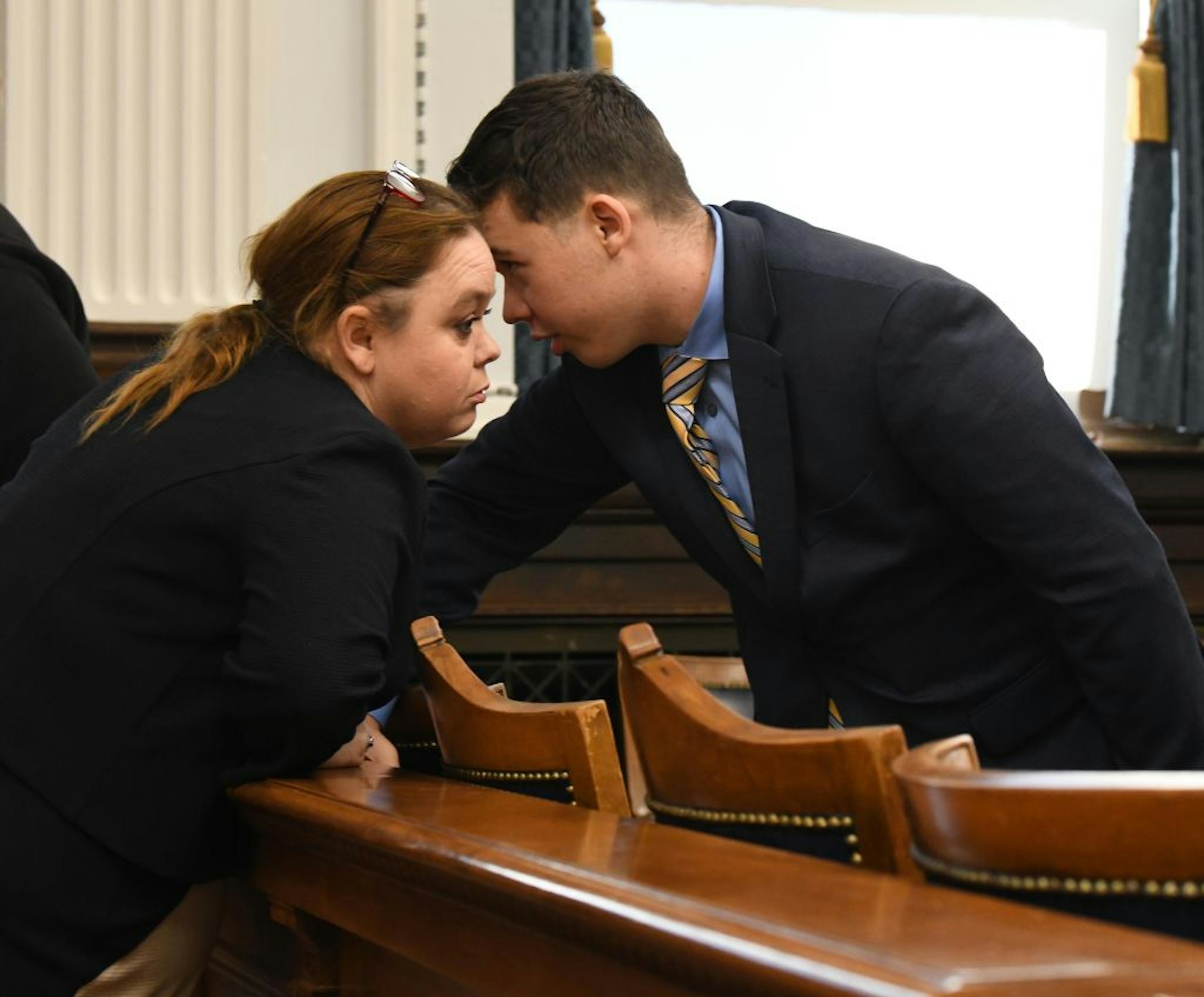 KENOSHA, WISCONSIN - NOVEMBER 03: Kyle Rittenhouse talks to his mother Wendy Rittenhouse during his trial at the Kenosha County Courthouse on November 3, 2021 in Kenosha, Wisconsin. Rittenhouse shot three demonstrators, killing two of them, during a night of unrest that erupted in Kenosha after a police officer shot Jacob Blake seven times in the back while police attempted to arrest him in August 2020. Rittenhouse, from Antioch, Illinois, was 17 at the time of the shooting and armed with an assault rifle. He faces counts of felony homicide and felony attempted homicide. (Photo by Mark Hertzberg-Pool/Getty Images)