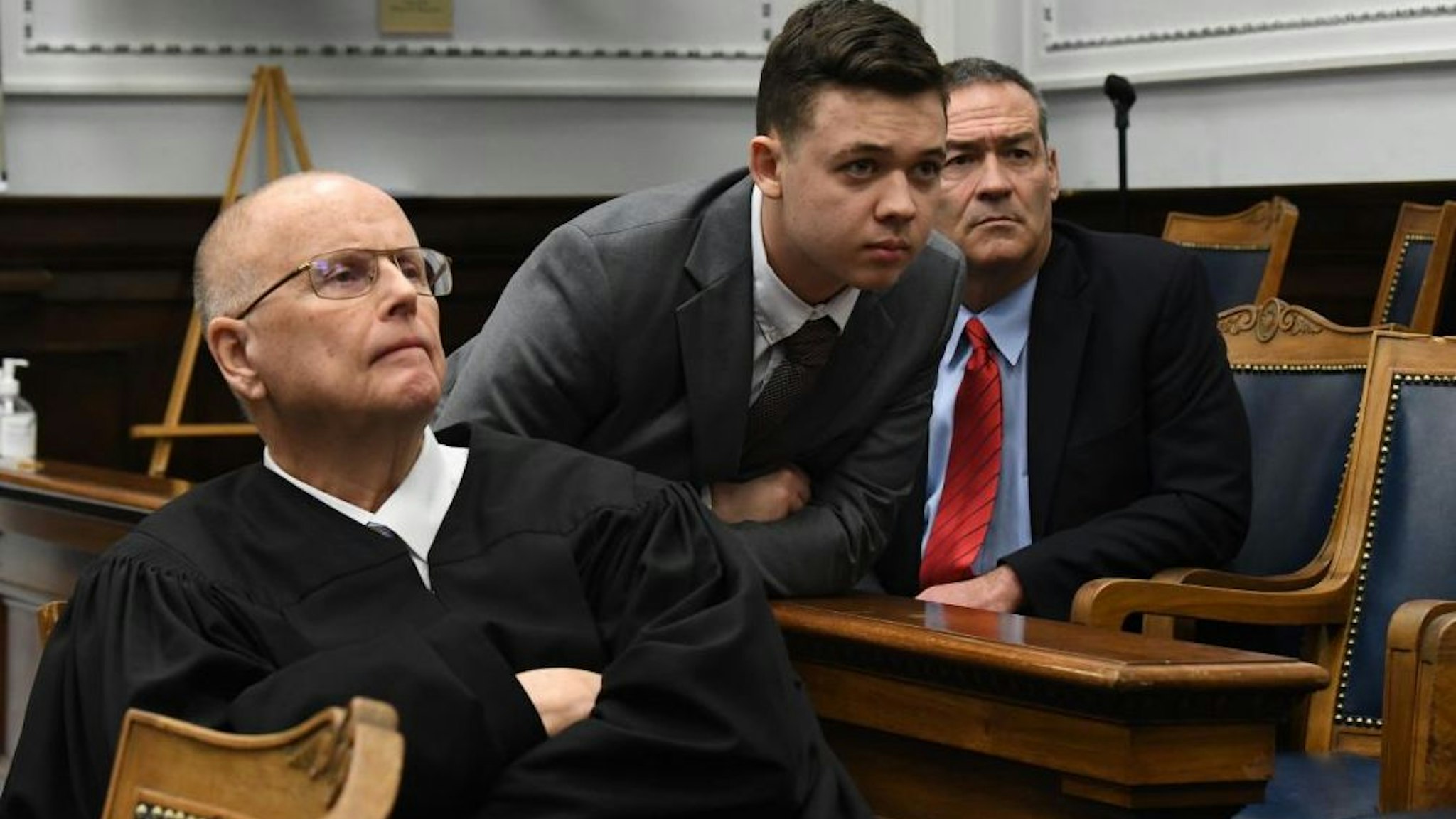 JUDGE BRUCE E. SCHROEDER is seated in front of a large video monitor as KYLE RITTENHOUSE and attorneys for both sides argue about a video in Kenosha (Wisconsin) Circuit Court on November 12, 2021 in Kenosha, Wisconsin.