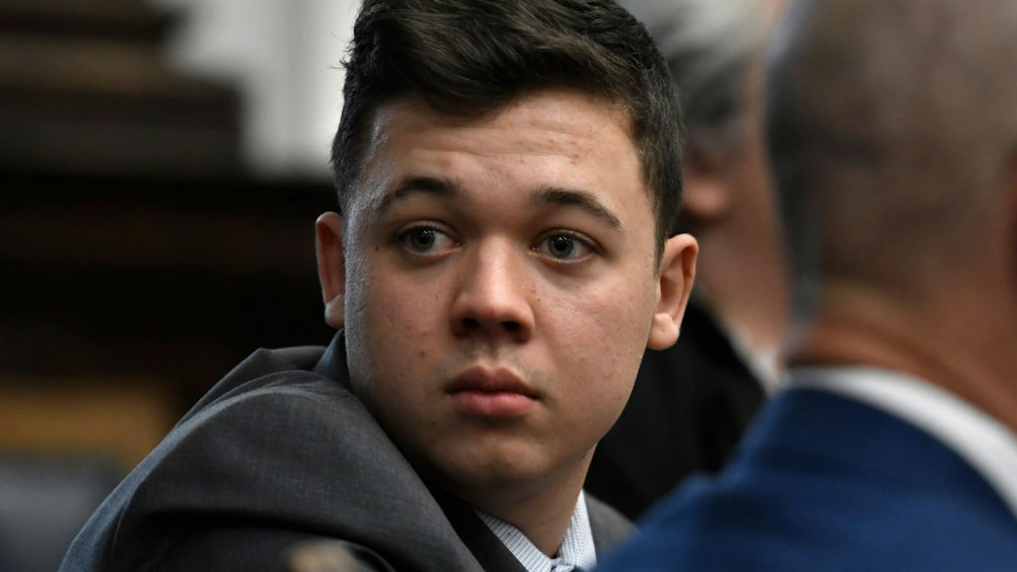 Kyle Rittenhouse looks back as attorneys discuss items in the motion for mistrial presented by his defense during his trial at the Kenosha County Courthouse on November 17, 2021 in Kenosha, Wisconsin.