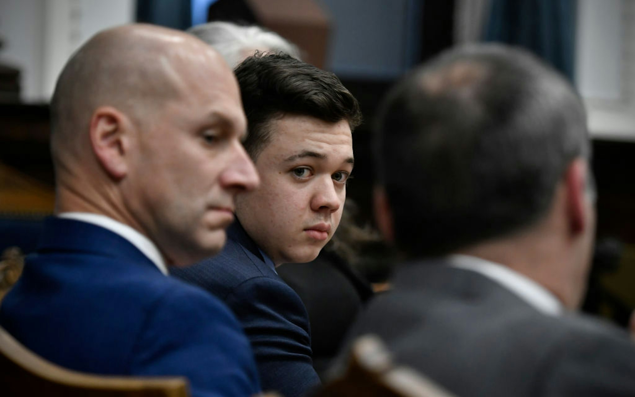 Kyle Rittenhouse, center, looks over to his attorneys as the jury is dismissed for the day during his trial at the Kenosha County Courthouse on November 18, 2021 in Kenosha, Wisconsin.