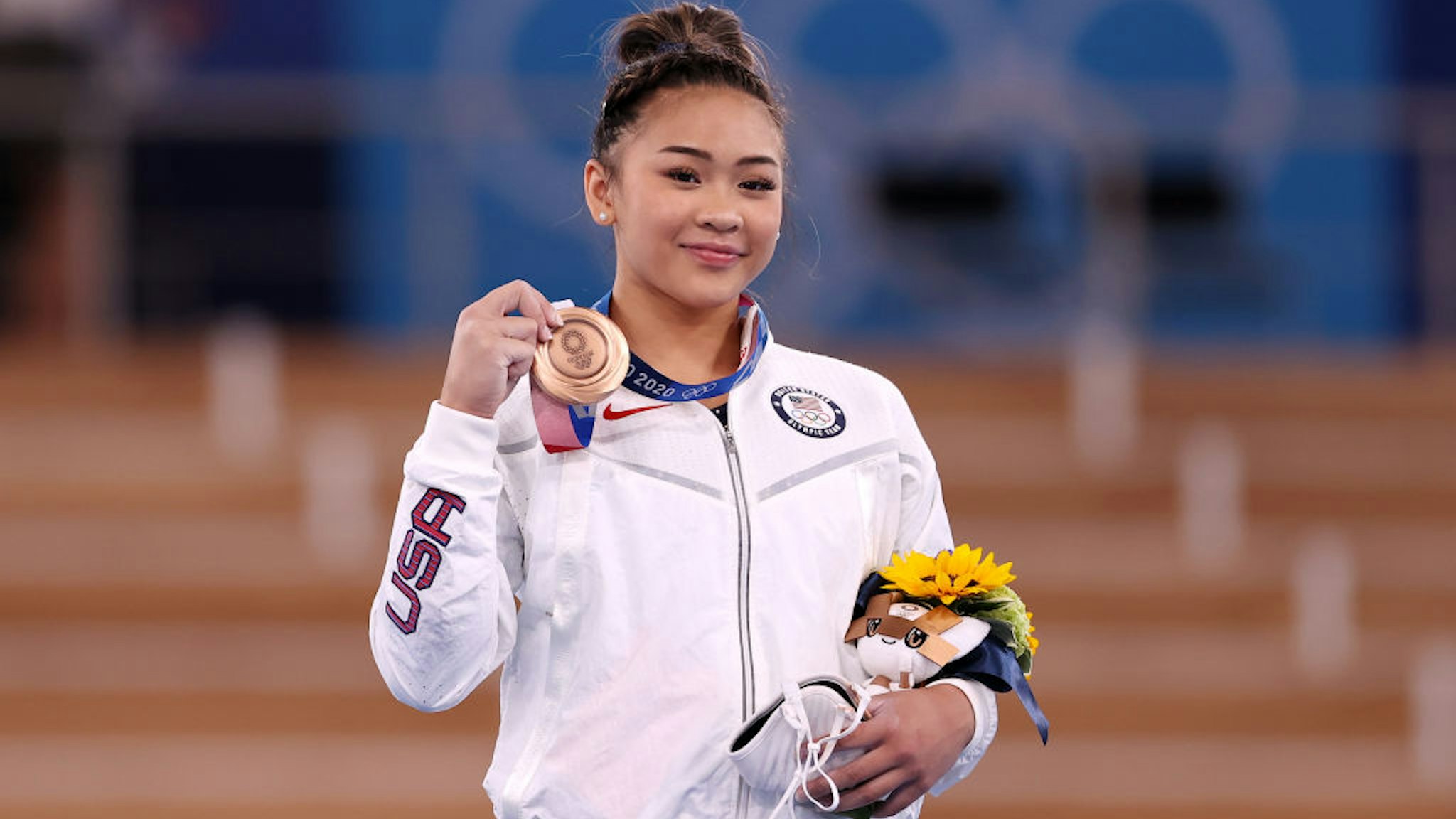 TOKYO, JAPAN - AUGUST 01: Bronze Medalist Sunisa Lee of Team United States poses with her medal on the podium during the Women's Uneven Bars Final medal ceremony on day nine of the Tokyo 2020 Olympic Games at Ariake Gymnastics Centre on August 01, 2021 in Tokyo, Japan. (Photo by Laurence Griffiths/Getty Images)