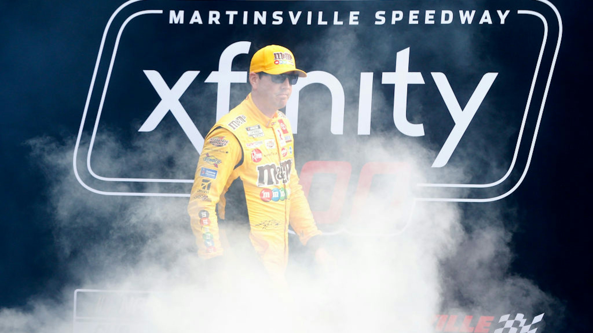 MARTINSVILLE, VIRGINIA - OCTOBER 31: Kyle Busch, driver of the #18 M&amp;M's Halloween Toyota, walks onstage during pre-race ceremonies prior to the NASCAR Cup Series Xfinity 500 at Martinsville Speedway on October 31, 2021 in Martinsville, Virginia. (Photo by Brian Lawdermilk/Getty Images)