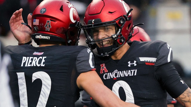 CINCINNATI, OHIO - NOVEMBER 20: Alec Pierce #12 and Desmond Ridder #9 of the Cincinnati Bearcats celebrate after scoring a touchdown in the second quarter against the SMU Mustangs at Nippert Stadium on November 20, 2021 in Cincinnati, Ohio. (Photo by Dylan Buell/Getty Images)