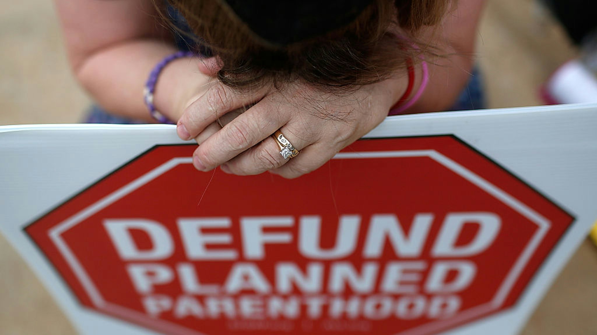 WASHINGTON, DC - SEPTEMBER 21: Right to Life advocate Linda Heilman prays during a sit-in in front of a proposed Planned Parenthood location while demonstrating the group's opposition to congressional funding of Planned Parenthood on September 21, 2015 in Washington, DC. The Right to Life groups who took part in the protest are also calling on Pope Francis to "address the pro-life issue and the defunding of Planned Parenthood" when he addresses Congress on September 24. (Photo by Win McNamee/Getty Images)