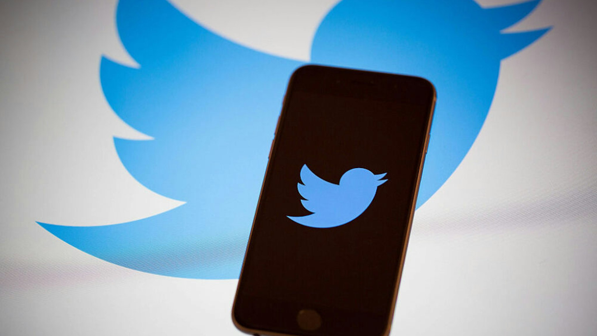 The Twitter Inc. logo is displayed on the screen of an Apple Inc. iPhone 6s in this arranged photograph taken in New York, U.S., on Tuesday, Feb. 9, 2016. Twitter Inc. is changing its timeline to display popular tweets first, instead of the latest posts, a long-anticipated step thats likely to anger its most passionate users. Twitter is scheduled to report quarterly earnings results following the close of U.S. financial markets on February 10.