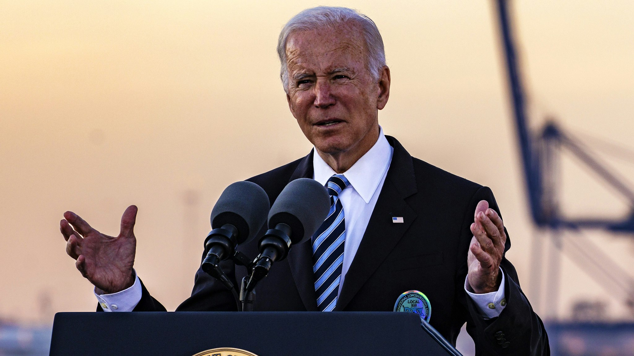 U.S. President Joe Biden speaks on the bipartisan infrastructure deal at the Port of Baltimore in Baltimore, Maryland, U.S., on Wednesday, Nov. 10, 2021. Biden is using the Baltimore port as a backdrop in his campaign to promote the $550 billion infrastructure legislation Congress cleared last week, $17 billion of which would go to ports.
