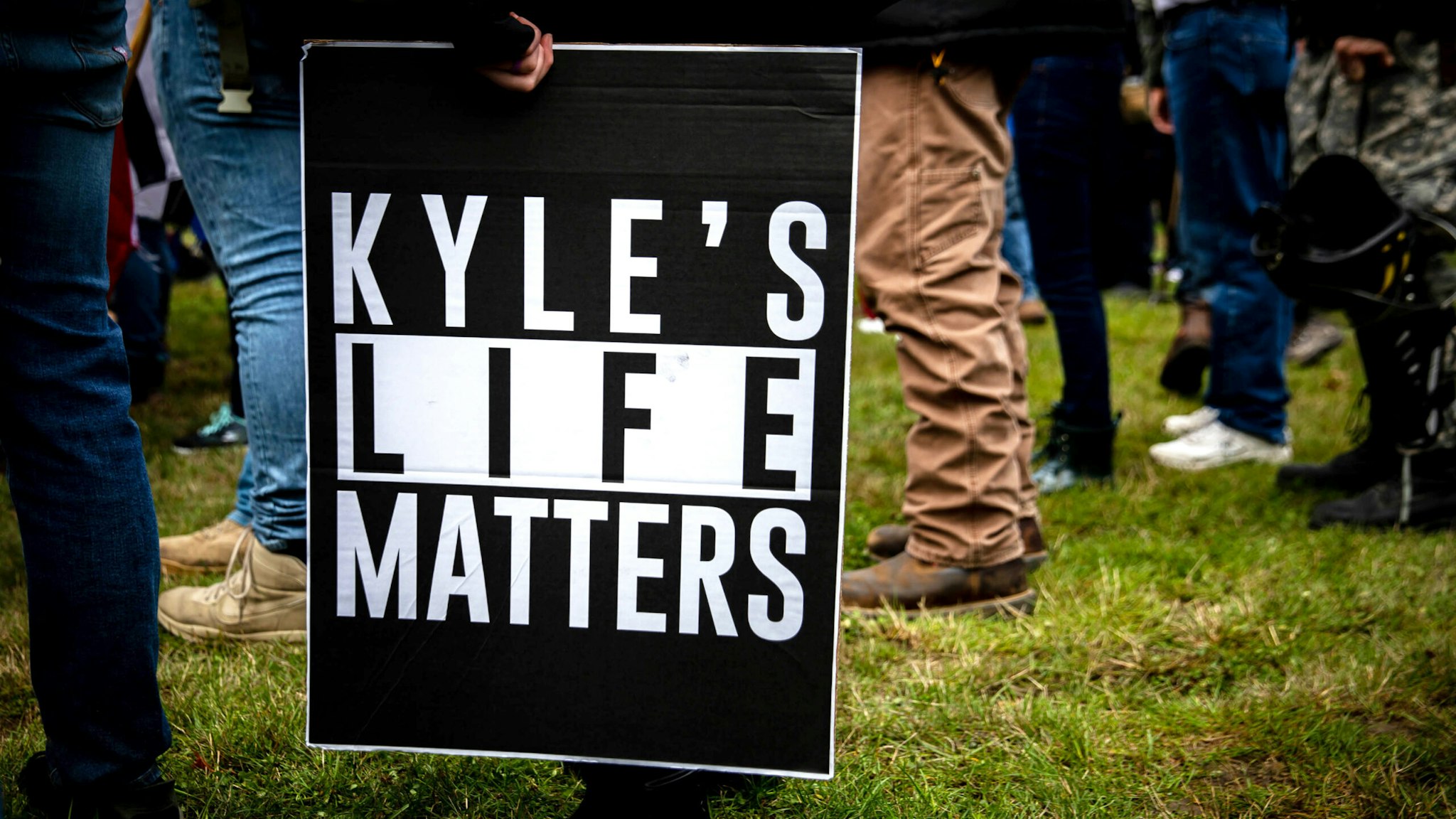 A person holds a sign that reads "Kyle's Life Matters", a reference to Kyle Rittenhouse, as several hundred members of the Proud Boys and other similar groups gathered at Delta Park in Portland, Oregon on September 26, 2020. - Far-right group "Proud Boys" members gather in Portland to show support to US president Donald Trump and to condemn violence that have been occurring for more than three months during "Black Lives Matter" and "Antifa" protests.