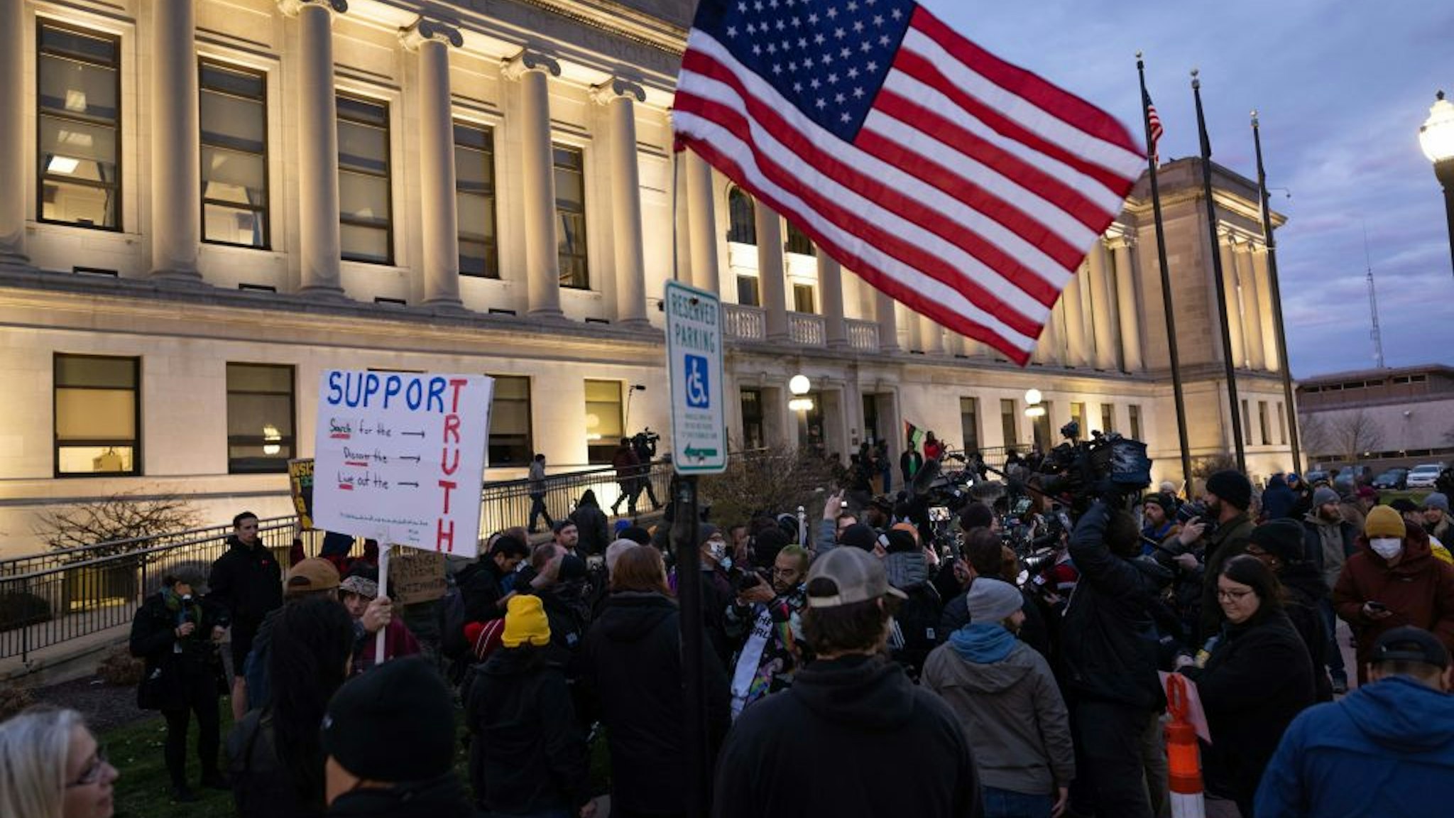 Demonstrators and members of the media outside of the Kenosha County Courthouse during the Kyle Rittenhouse trial in Kenosha, Wisconsin, U.S., on Wednesday, Nov. 17, 2021. Rittenhouse, 18, is accused of homicide in the deaths of Joseph Rosenbaum and Anthony Huber, as well as attempted homicide for shooting Gaige Grosskreutz.