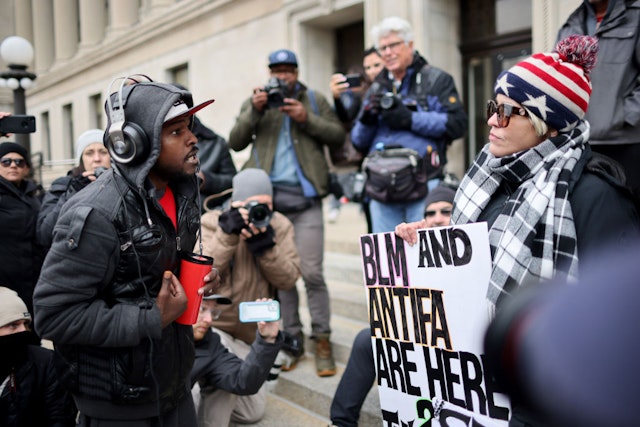 KENOSHA, WISCONSIN - NOVEMBER 16: Demonstrators with opposing views gather outside of the Kenosha County Courthouse as the jury deliberates in the trial of Kyle Rittenhouse on November 16, 2021 in Kenosha, Wisconsin. Rittenhouse faces charges of felony homicide and felony attempted homicide for the fatal shootings of Joseph Rosenbaum and Anthony Huber and for shooting and wounding Gaige Grosskreutz during unrest in Kenosha that followed the police shooting of Jacob Blake in August 2020.