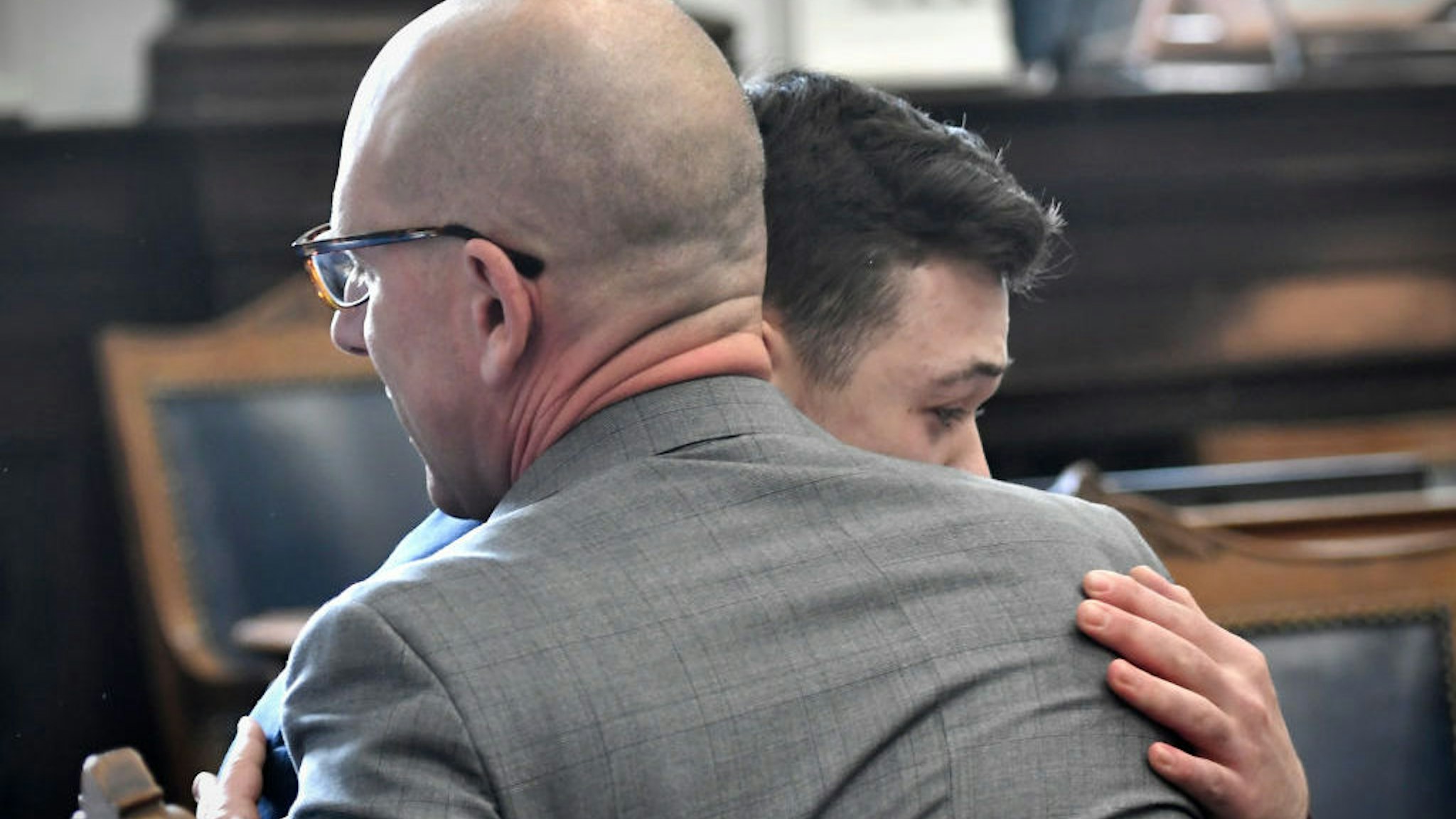 KENOSHA, WISCONSIN - NOVEMBER 19: Kyle Rittenhouse hugs one of his attorneys, Corey Chirafisi, after he is found not guilty in his trial at the Kenosha County Courthouse on November 19, 2021 in Kenosha, Wisconsin. Rittenhouse was found not guilty of all charges in the shooting of three demonstrators, killing two of them, during a night of unrest that erupted in Kenosha after a police officer shot Jacob Blake seven times in the back while being arrested in August 2020. Rittenhouse, from Antioch, Illinois, claimed self-defense who at the time of the shooting was armed with an assault rifle. (Photo by Sean Krajacic - Pool/Getty Images)