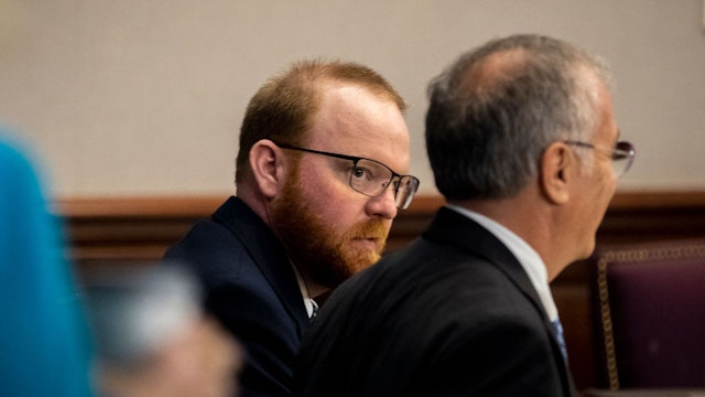 Travis McMichael, center, listens to his attorney Bob Rubin, right, during his trial in the Glynn County Courthouse, Tuesday, Nov. 16, 2021, in Brunswick, Ga. Travis McMichael, his father Greg McMichael and William "Roddie" Bryan are charged with the February 2020 slaying of 25-year-old Ahmaud Arbery.