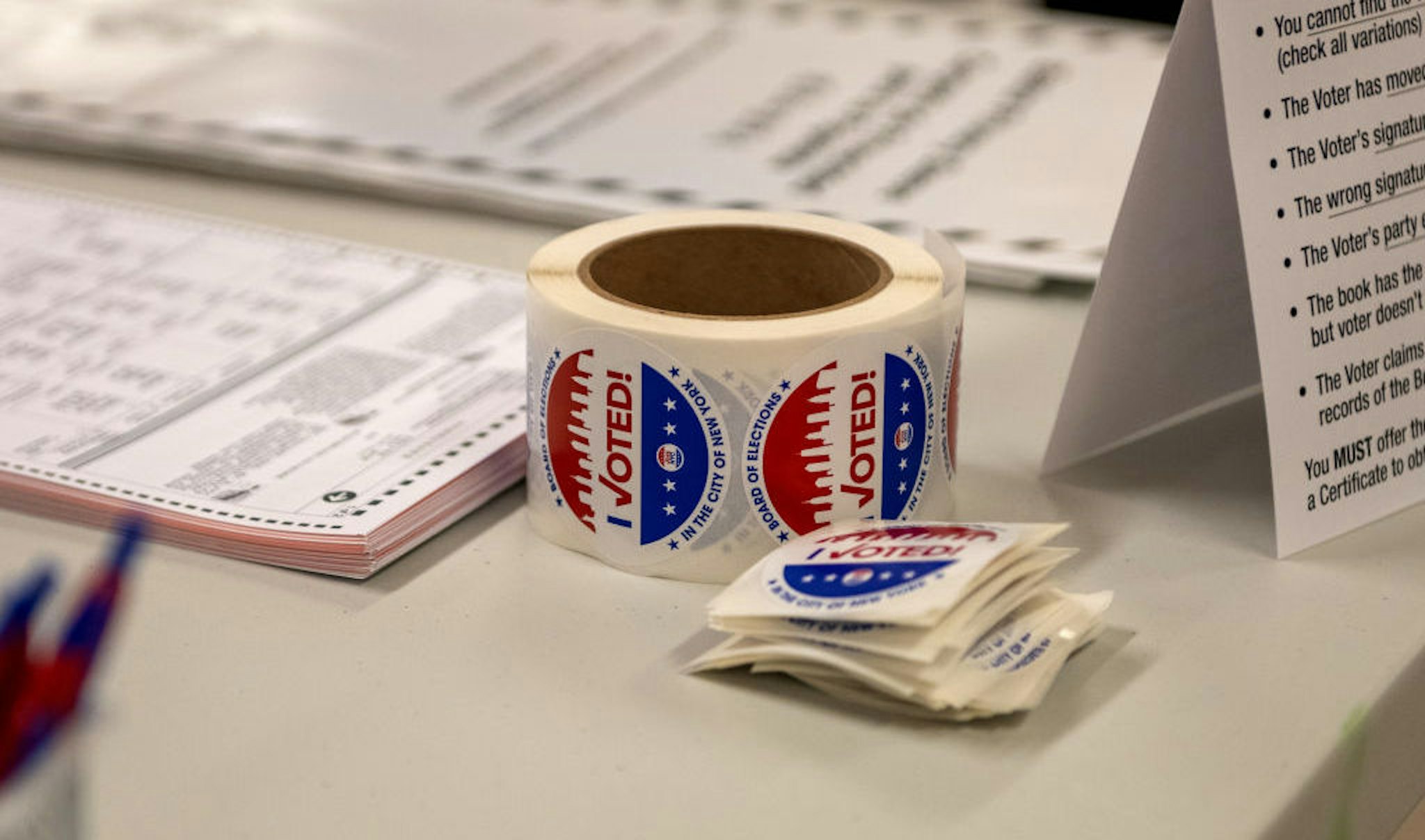 NEW YORK, NEW YORK - NOVEMBER 02: A roll of "I voted" stickers is left on a table at a polling site on the Upper West Side on November 2, 2021 in New York City. Republican mayoral candidate Curtis Sliwa was told by Board of Election officials he could not vote with his pet cat, Gizmo, and then was told he could not wear his signature red campaign windbreaker. After being allowed to vote despite wearing his windbreaker, the ballot machine became jammed, forcing election officials to step in and fix it. Sliwa's ballot was retrieved and successfully processed after over an hour. (Photo by Alexi Rosenfeld/Getty Images)