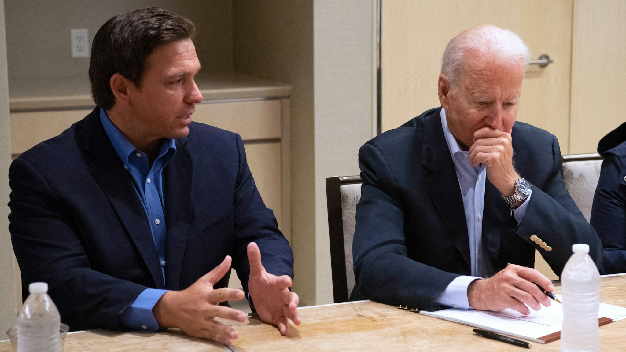 US President Joe Biden alongside Florida Governor Ron DeSantis (L) speaks about the collapse of the 12-story Champlain Towers South condo building in Surfside, during a briefing in Miami Beach, Florida, July 1, 2021. - President Joe Biden flew to Florida on Thursday to "comfort" families of people killed or still missing in the rubble of a beachfront apartment building, where hopes of finding survivors had all but evaporated. Biden and First Lady Jill Biden left the White House early for the flight to Miami, and then traveled by motorcade to nearby Surfside, where the death toll in the tragedy now stands at 18, and more than 140 still unaccounted for.