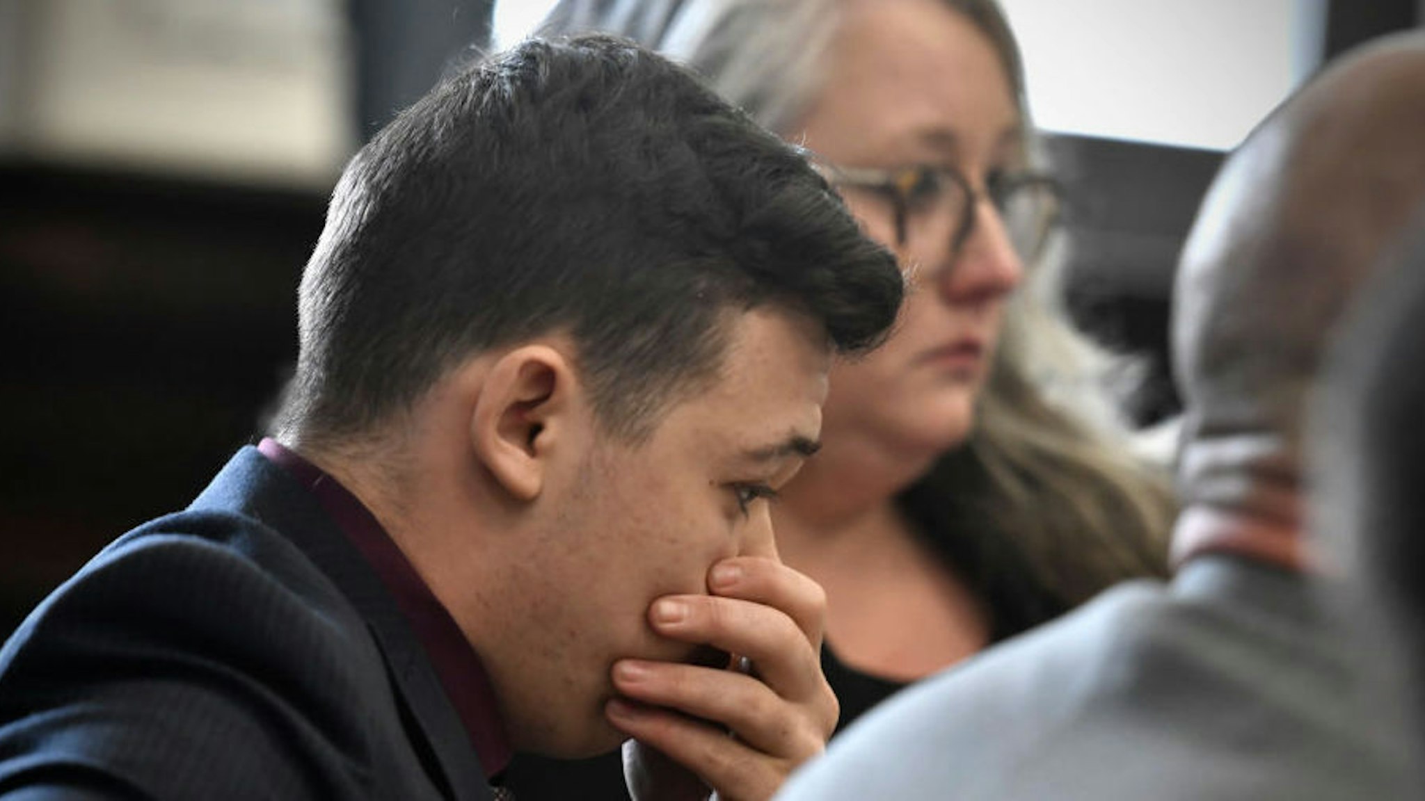 KENOSHA, WISCONSIN - NOVEMBER 19: Kyle Rittenhouse puts his hand over his face as he is found not guilty on all counts at the Kenosha County Courthouse on November 19, 2021 in Kenosha, Wisconsin. Rittenhouse was found not guilty of all charges in the shooting of three demonstrators, killing two of them, during a night of unrest that erupted in Kenosha after a police officer shot Jacob Blake seven times in the back while being arrested in August 2020. Rittenhouse, from Antioch, Illinois, claimed self-defense who at the time of the shooting was armed with an assault rifle.