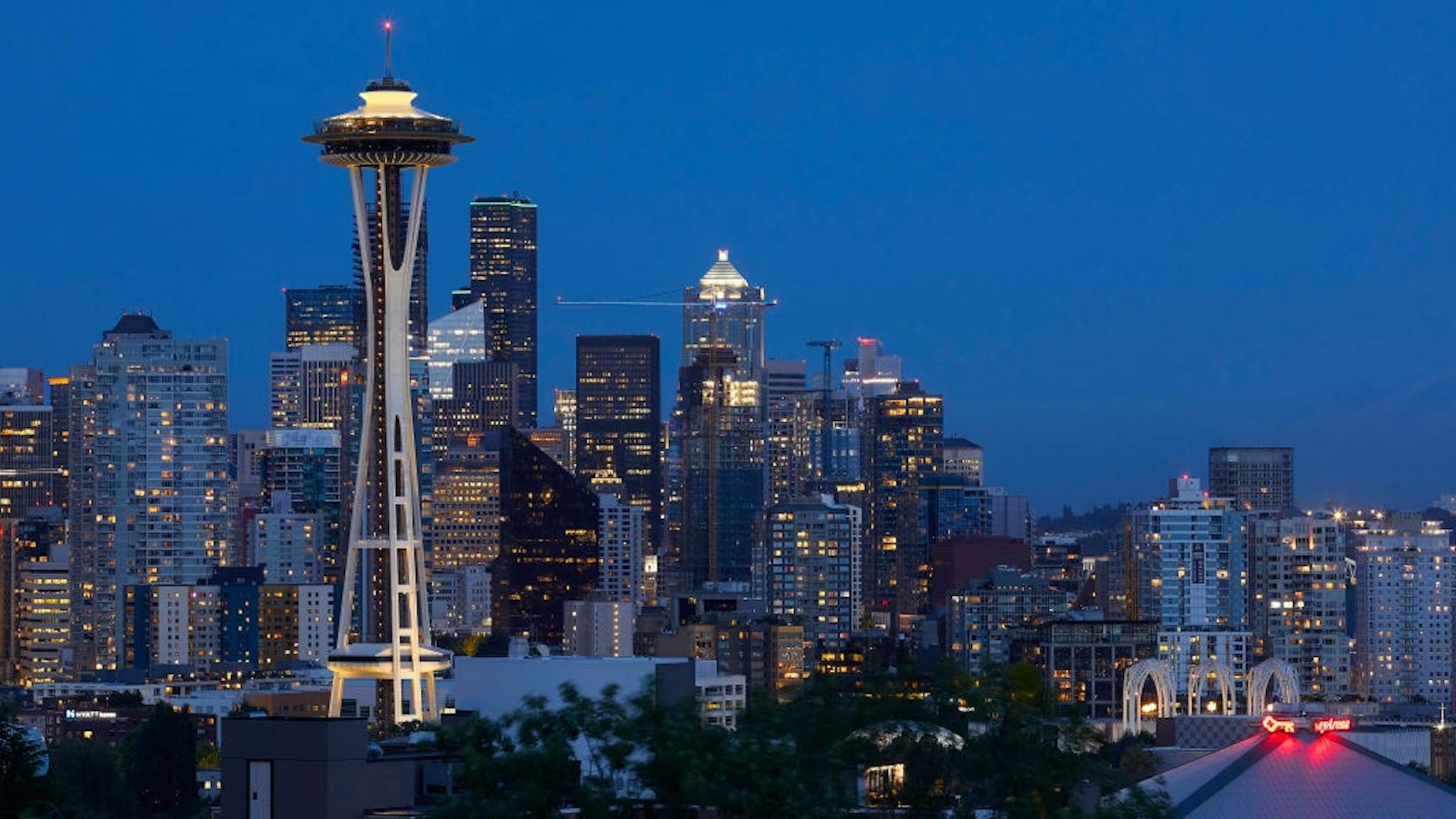 Illuminated tower and city at night. Space Needle, Seattle, United States. Architect: Olson Kundig, 2020.