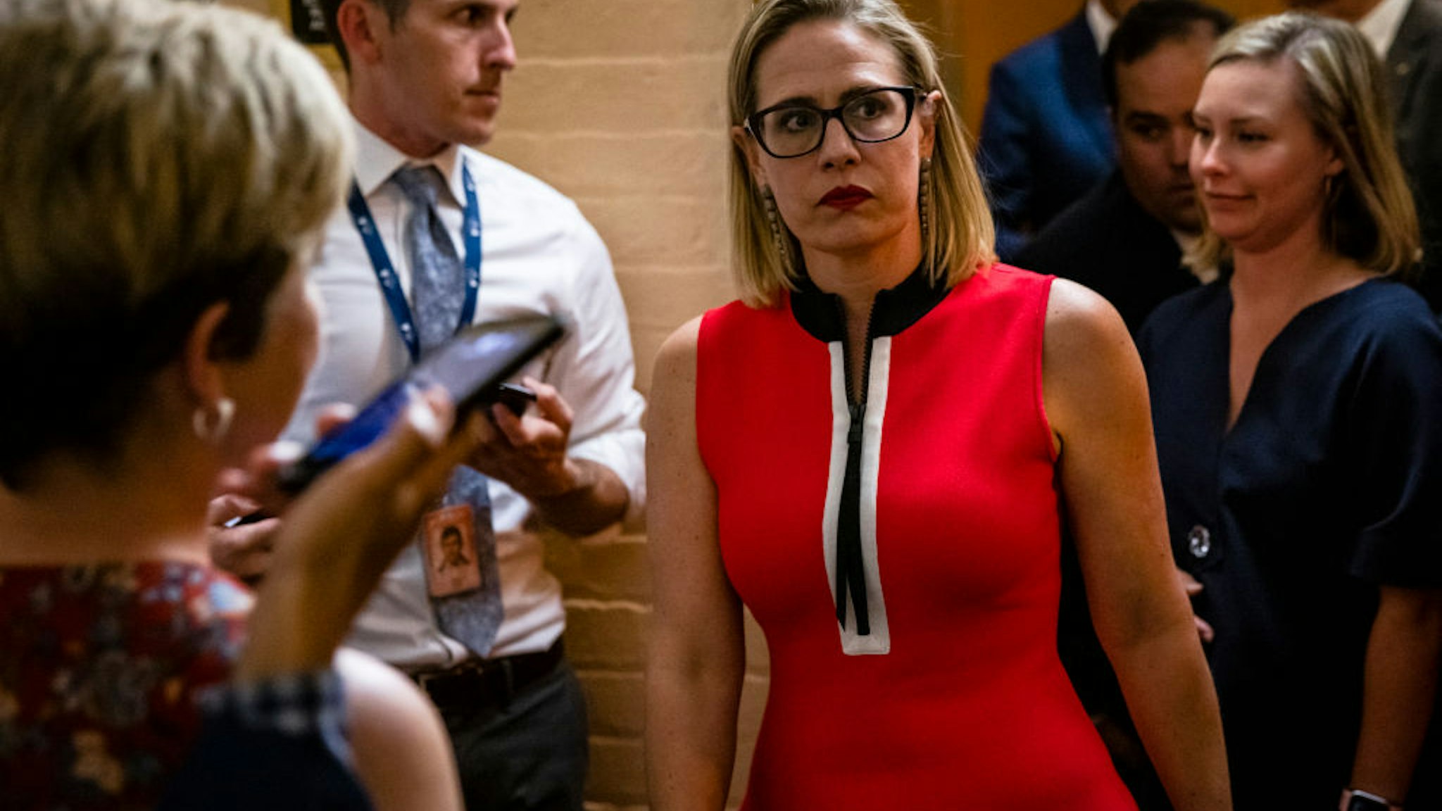 WASHINGTON, DC - JUNE 08: U.S. Sen. Kirsten Sinema (D-AZ) heads back to a bipartisan meeting on infrastructure in the basement of the U.S. Capitol building after the original talks fell through with the White House on June 8, 2021 in Washington, DC. Senate Majority Leader Chuck Schumer (D-NY) said they are now pursuing a two-path proposal that includes a new set of negotiations with a bipartisan group of senators.