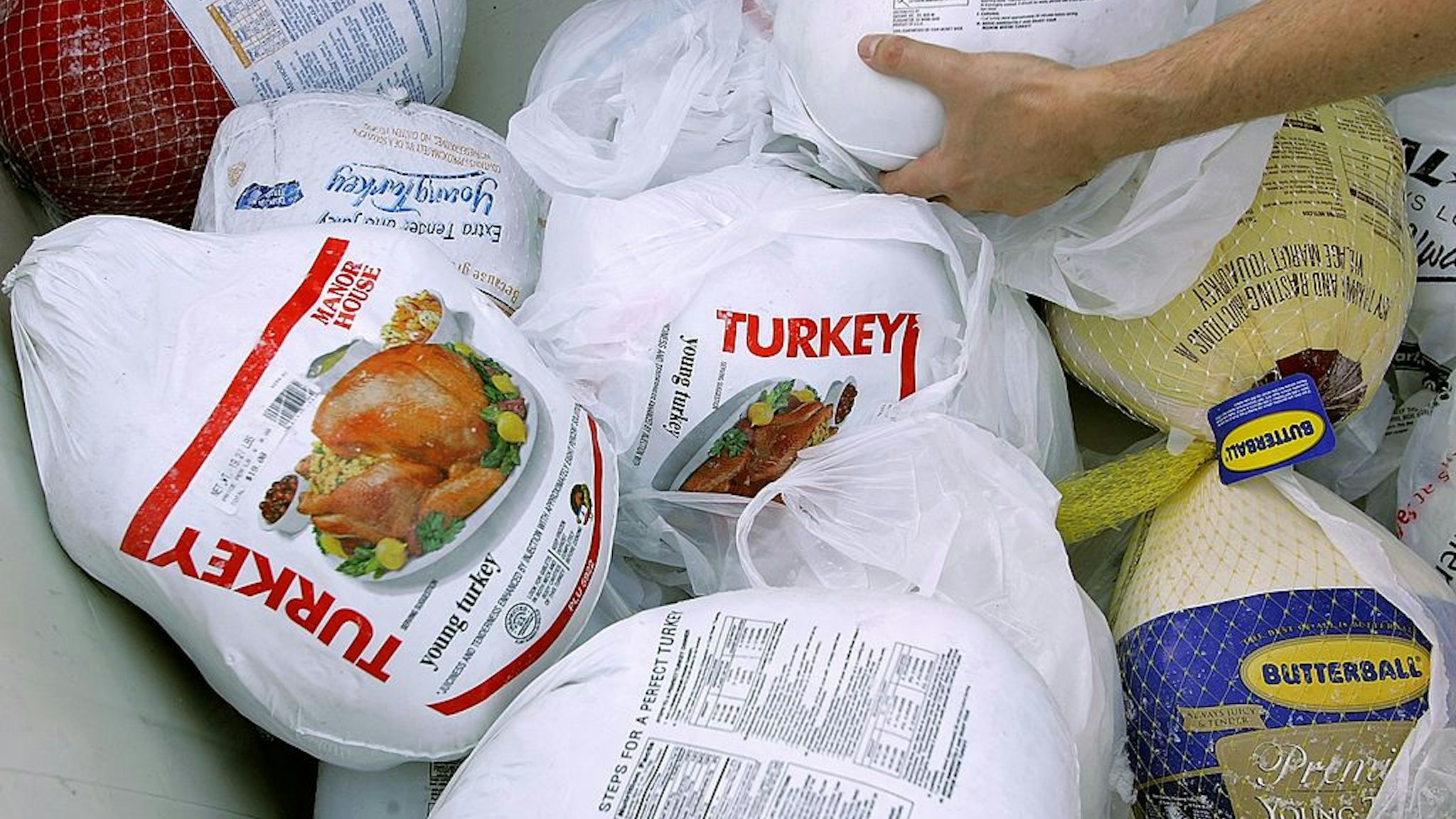 SAN FRANCISCO - NOVEMBER 21: A volunteer prepares a box of turkeys to be given out during the 2006 holiday turkey distribution at the San Francisco Food Bank November 21, 2006 in San Francisco, California. Despite donations being down at most food banks across the country, the San Francisco Food Bank will distribute over 1,500 turkeys to churches and community centers over the holiday season.