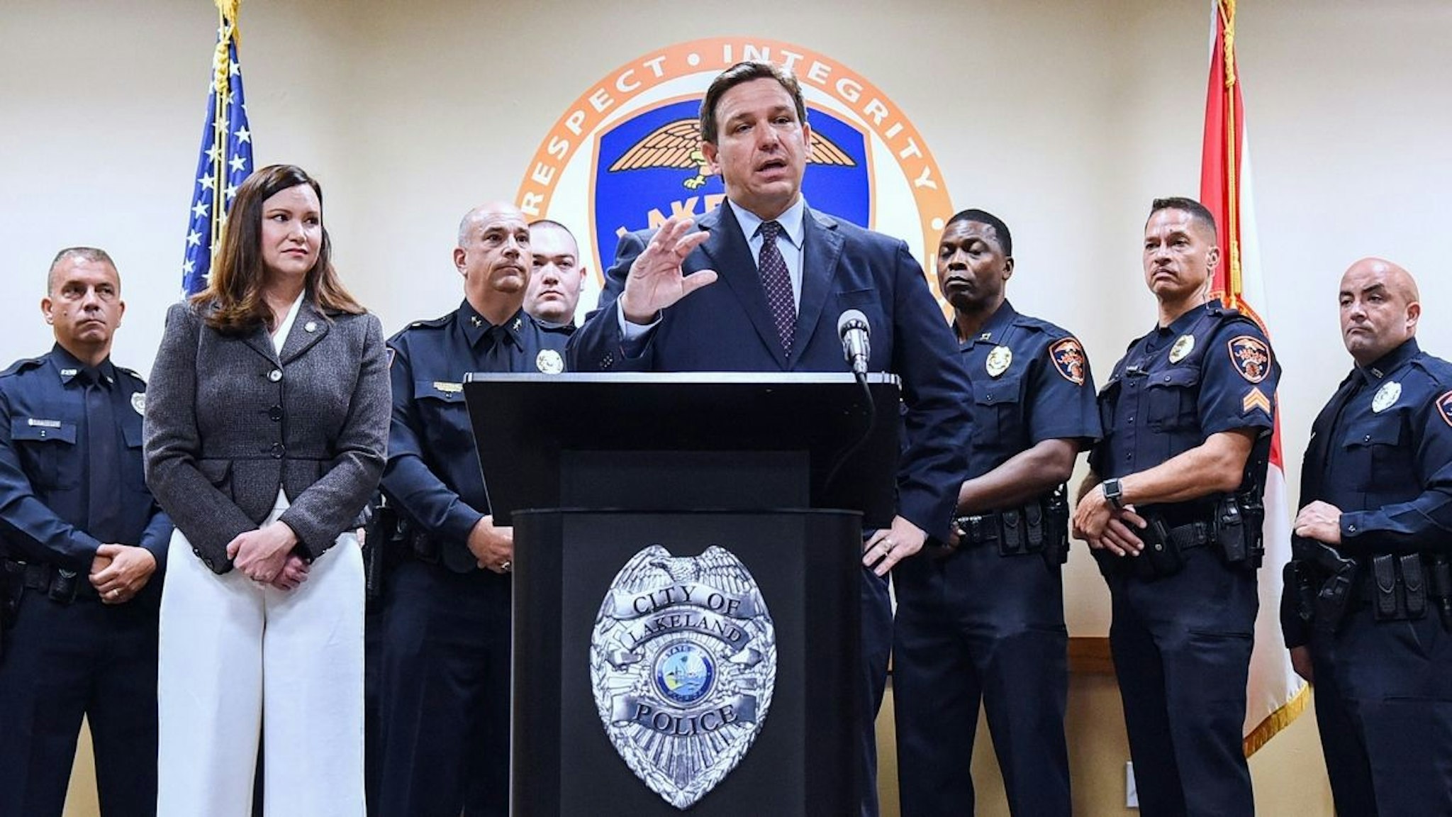 Florida Attorney General Ashley Moody ( second left) looks on as Governor Ron DeSantis speaks at a press conference at the Lakeland, Florida Police Department to announce a new proposal that would provide $5,000 signing bonuses to those who sign on to be law enforcement officers from within the state of Florida, and those who come from out-of-state.