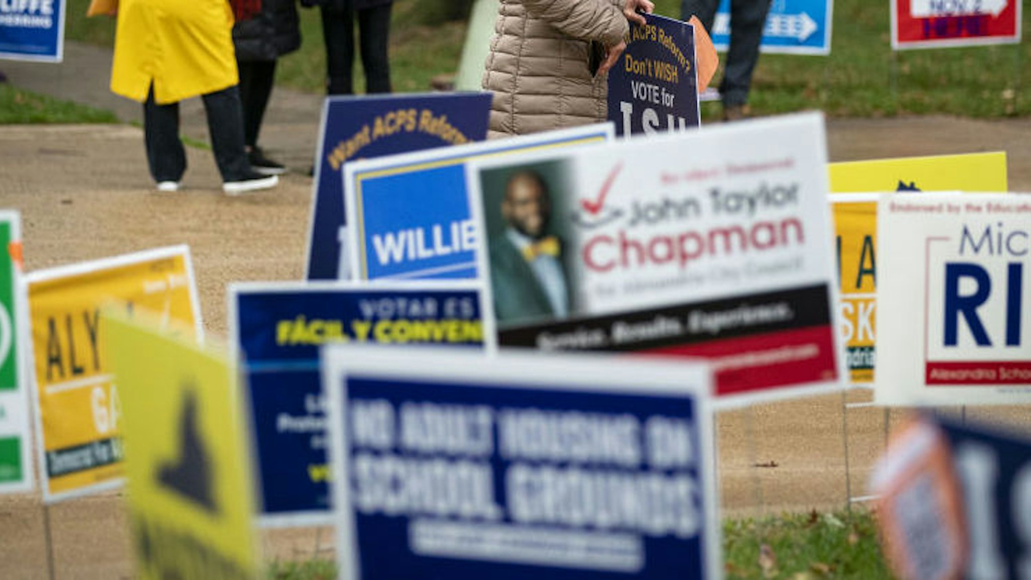 Campaign signs outside of a polling location in Alexandria, Virginia, U.S., on Tuesday, Nov. 2, 2021. Virginia's gubernatorial contest between Terry McAuliffe and Glenn Youngkin will offer the clearest picture yet of how much momentum Republicans have heading into 2022 elections that will decide control of Congress.