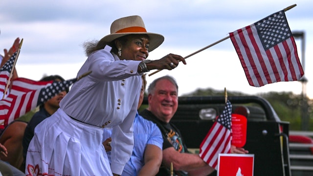 Ashburn, VA - JUNE 30: Nominee for Lieutenant Governor of Virginia Winsome Sears waves her flag to the audience in support of the opposition of critical race theory in Loudoun County Schools on June 30, 2021, in Ashburn, VA. Loudoun County locals came to protest the teaching of critical race theory, and to see Republican nominee for Virginia Governor Glenn Youngkin give a speech.