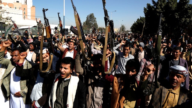 SANAA, Jan. 18, 2021 -- Houthi fighters walk in front of the closed U.S. embassy to protest against the U.S. designation of the Houthi militia as "a terrorist organization" in Sanaa, Yemen, Jan. 18, 2021.