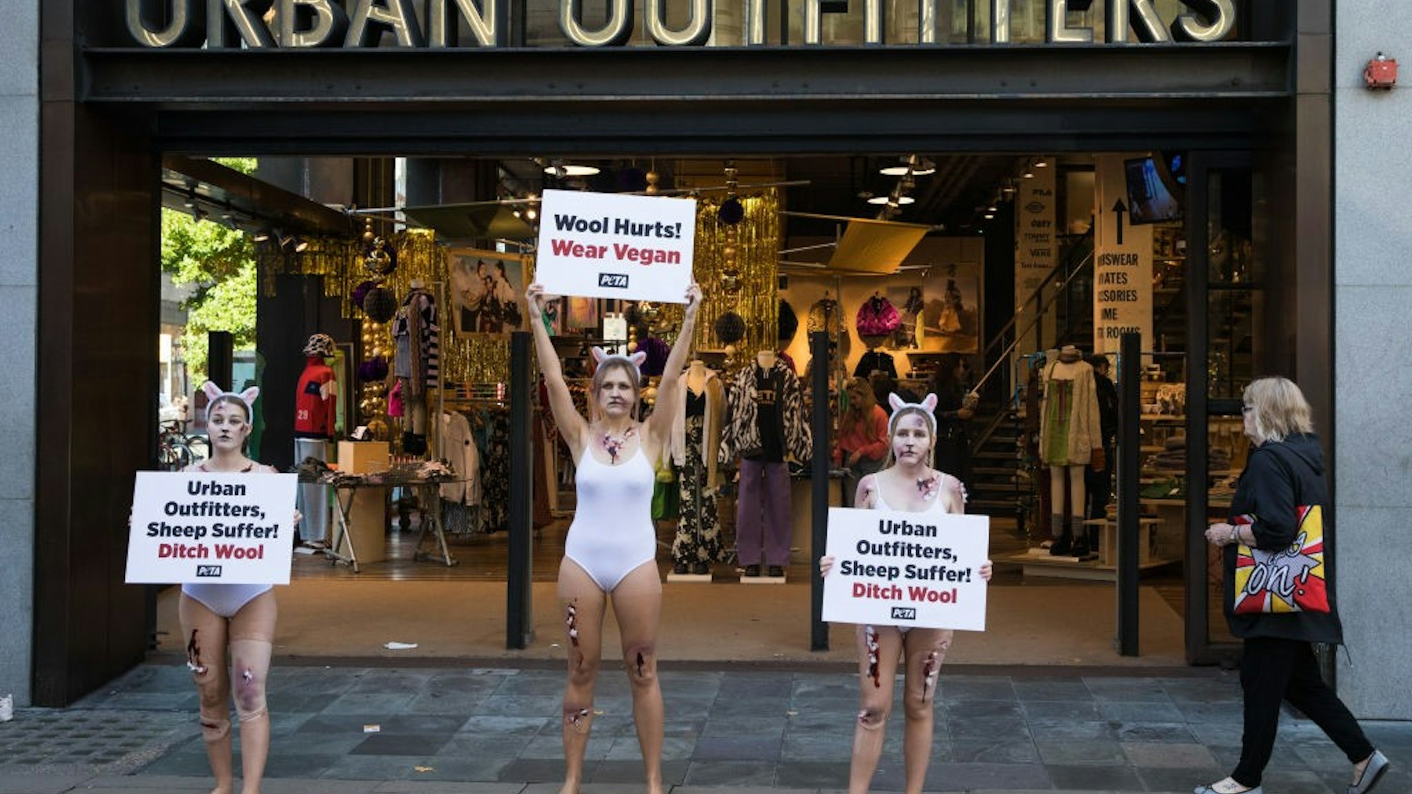 PETA supporters dressed as bloodied sheep protest outside a branch of Urban Outfitters in Oxford Street to call for an end to wool sales on 21st October 2021 in London, United Kingdom. The protest forms part of an international PETA campaign to urge Urban Outfitters Inc brands including Anthropologie and Free People to stop selling materials cruelly taken from animals. (photo by