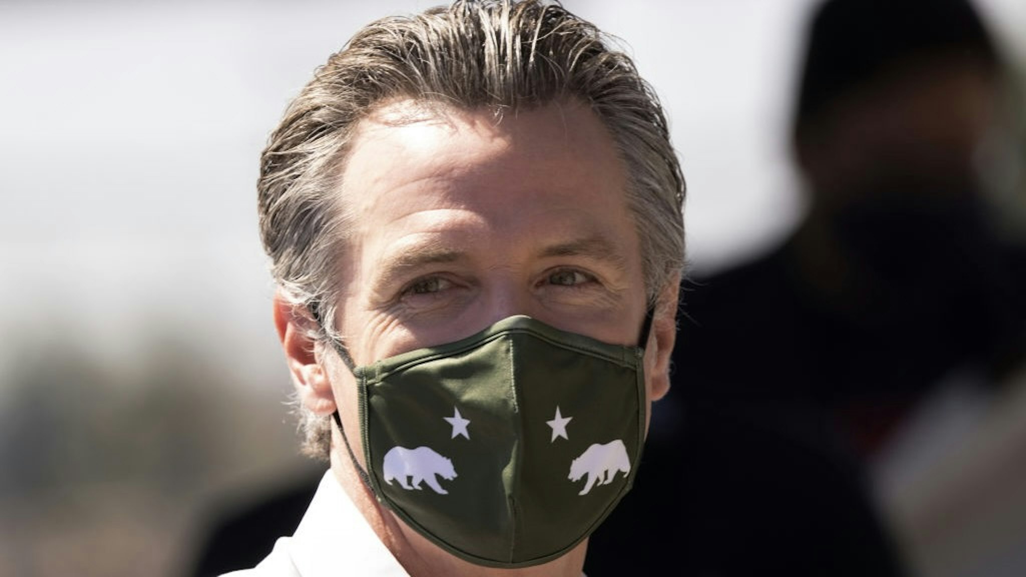 California Governor Newsom Campaigns With Sen. Elizabeth Warren In Culver City CULVER CITY, CA - SEPTEMBER 04: Gov. Gavin Newsom wears a California state themed face mask at a "Stop the Republican Recall" rally as he campaigns with Sen. Elizabeth Warren, D-Massachusetts, at Culver City High School on September 4, 2021 in Culver City, California. Forty-six candidates, mostly Republicans, are running to overthrow the governor in this years special recall election on September 14, ahead of next years regularly scheduled gubernatorial vote. (Photo by David McNew/Getty Images) David McNew / Stringer