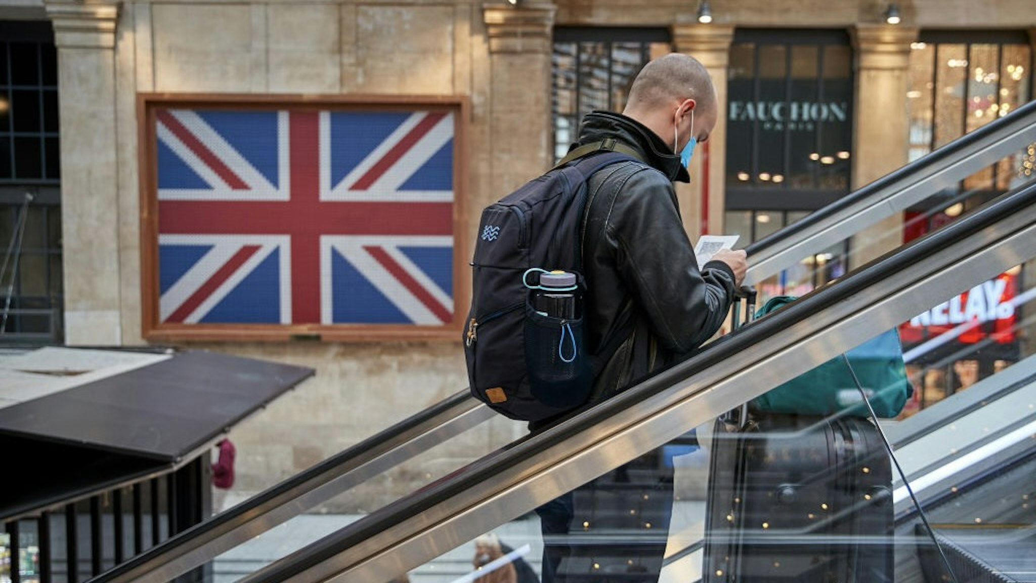 France Tightens Travel Restrictions With UK To Curb Covid-19 Omicron Variant Infections PARIS, FRANCE - DECEMBER 16: A passenger takes an escalator past a giant Union Flag to the Eurostar terminal at Paris Gare du Nord station as new travel restrictions between the UK and France are announced in response to the Omicron variant on December 16, 2021 in Paris, France. The French government announced that all travel leaving or returning from the United Kingdom will be restricted as of December 18th due to the rising cases of the Omicron variant. (Photo by Kiran Ridley/Getty Images) Kiran Ridley / Contributor