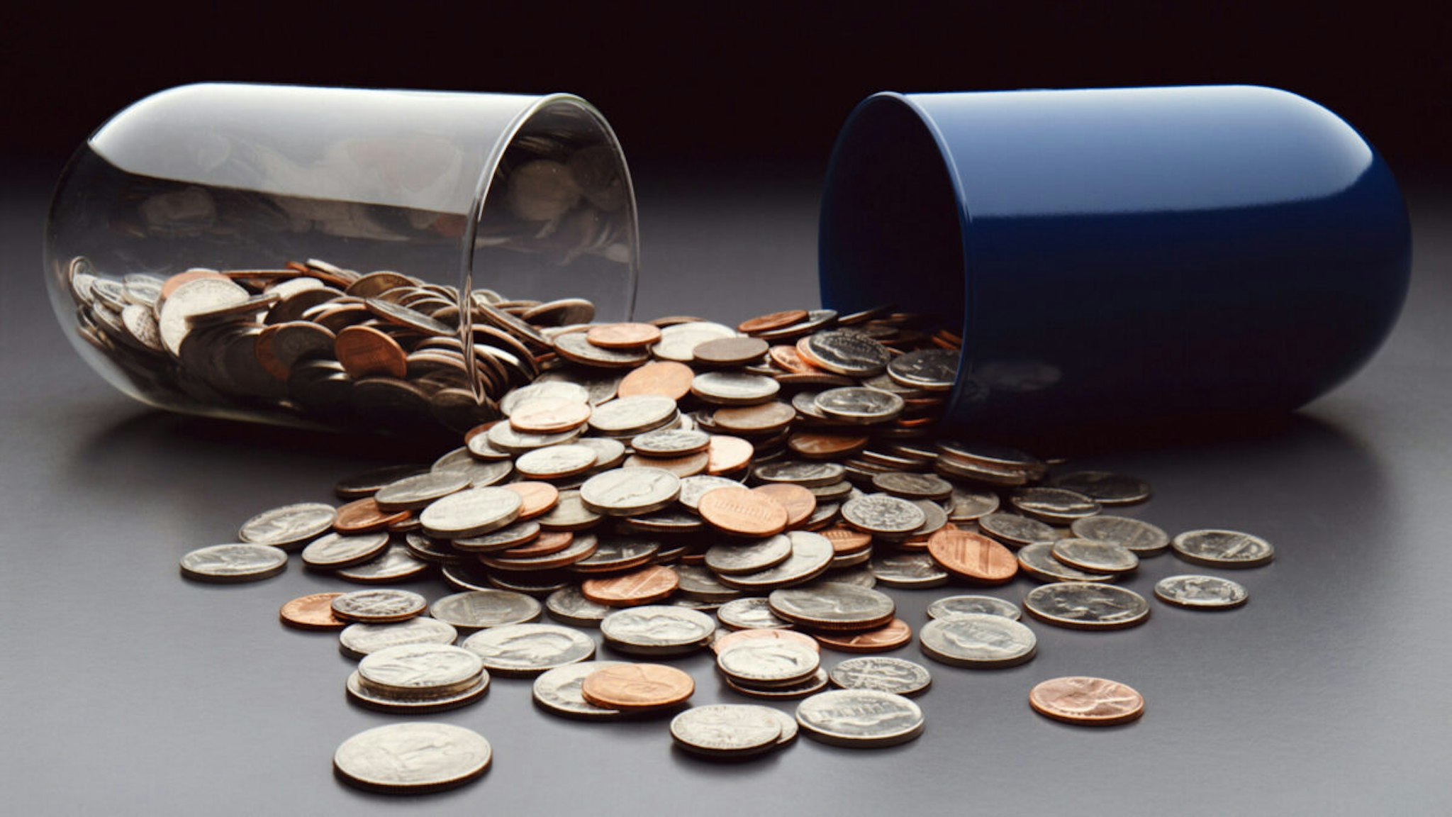 USA coins spilling out of broken capsule - stock photo.