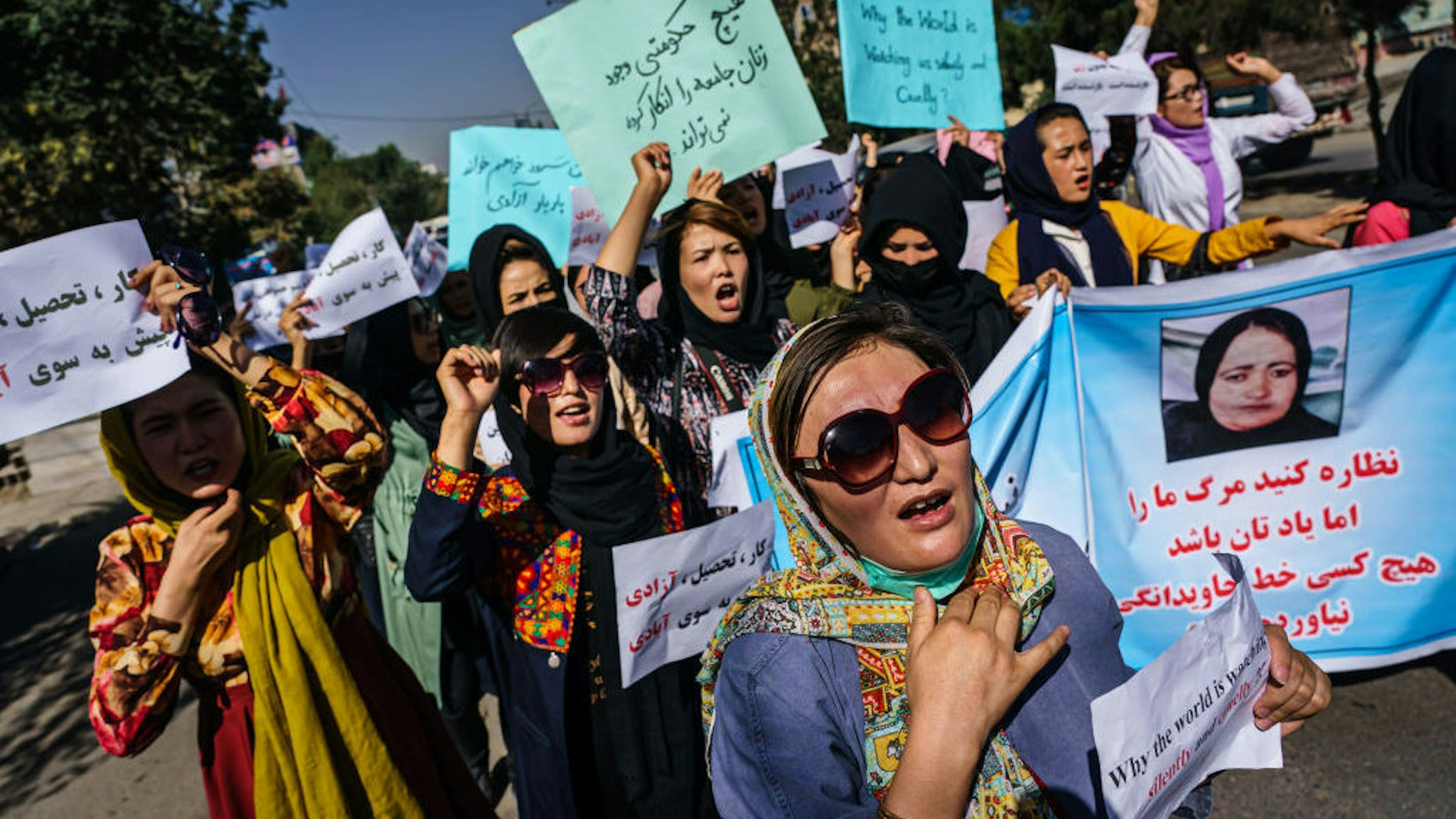 KABUL, AFGHANISTAN -- SEPTEMBER 8, 2021: Protesters march through the Dashti-E-Barchi neighborhood, a day after the Taliban announced their new all-male interim government with a no representation for women and ethnic minority groups, in Kabul, Afghanistan, Wednesday, Sept. 8, 2021. (MARCUS YAM / LOS ANGELES TIMES)
