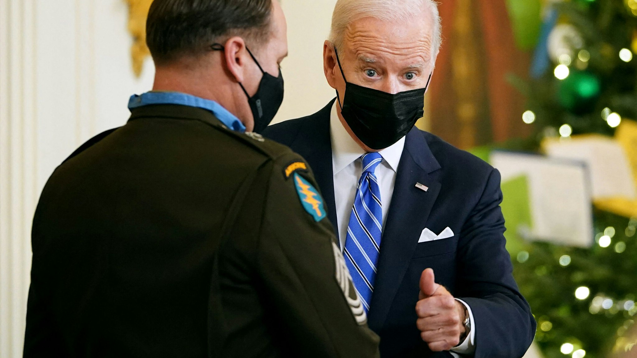 US President Joe Biden gives a thumbs up after presenting the Medal of Honor to US Army Master Sergeant Earl D. Plumlee during a ceremony in the East Room of the White House in Washington, DC on December 16, 2021.