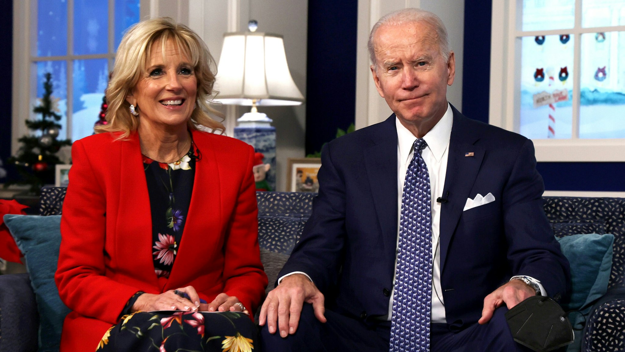 WASHINGTON, DC - DECEMBER 24: U.S. President Joe Biden and first lady Dr. Jill Biden participate in an event to call NORAD and track the path of Santa Claus on Christmas Eve in the South Court Auditorium of the Eisenhower Executive Building on December 24, 2021 in Washington, DC. The president and first lady also called to speak to Americans and thank military families.