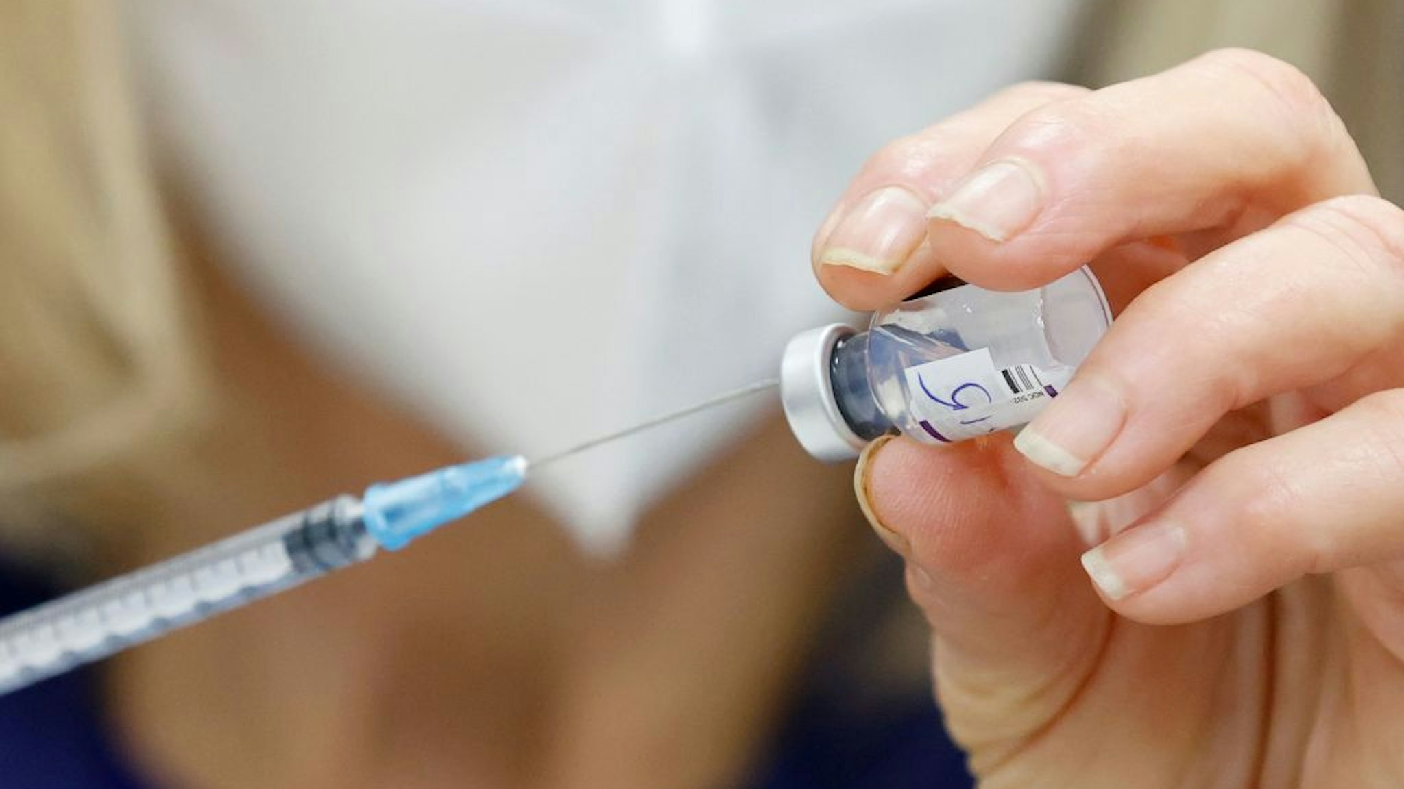 An Israeli nurse prepares a dose of the Pfizer-BioNTech COVID-19 coronavirus vaccine at the Sheba Medical Center in Ramat Gan near Tel Aviv, on December 27, 2021, as the Israeli hospital conducted a trial of the vaccine's fourth jab on staff volunteers. (Photo by JACK GUEZ / AFP) (Photo by JACK GUEZ/AFP via Getty Images)
