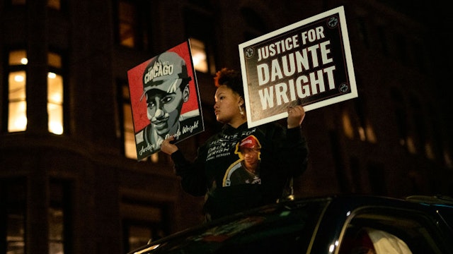 MINNEAPOLIS, MN - NOVEMBER 30: Diamond Wright, the sister of Daunte Wright, holds signs during a demonstration march on November 30, 2021 in Minneapolis, Minnesota. Jury selection starts today in the trial of former Brooklyn Center police officer Kim Potter, who is charged with manslaughter in the April 2021 shooting death of Daunte Wright. Potter claims she thought she was using her taser when she shot Wright with her handgun. (Photo by Stephen Maturen/Getty Images)