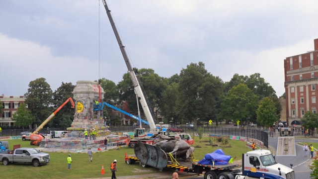 The dismantled Robert E. Lee statue is hauled away on a flatbed trailer after its removal from its pedestal on Monument Avenue in Richmond, VA on September 8, 2021.