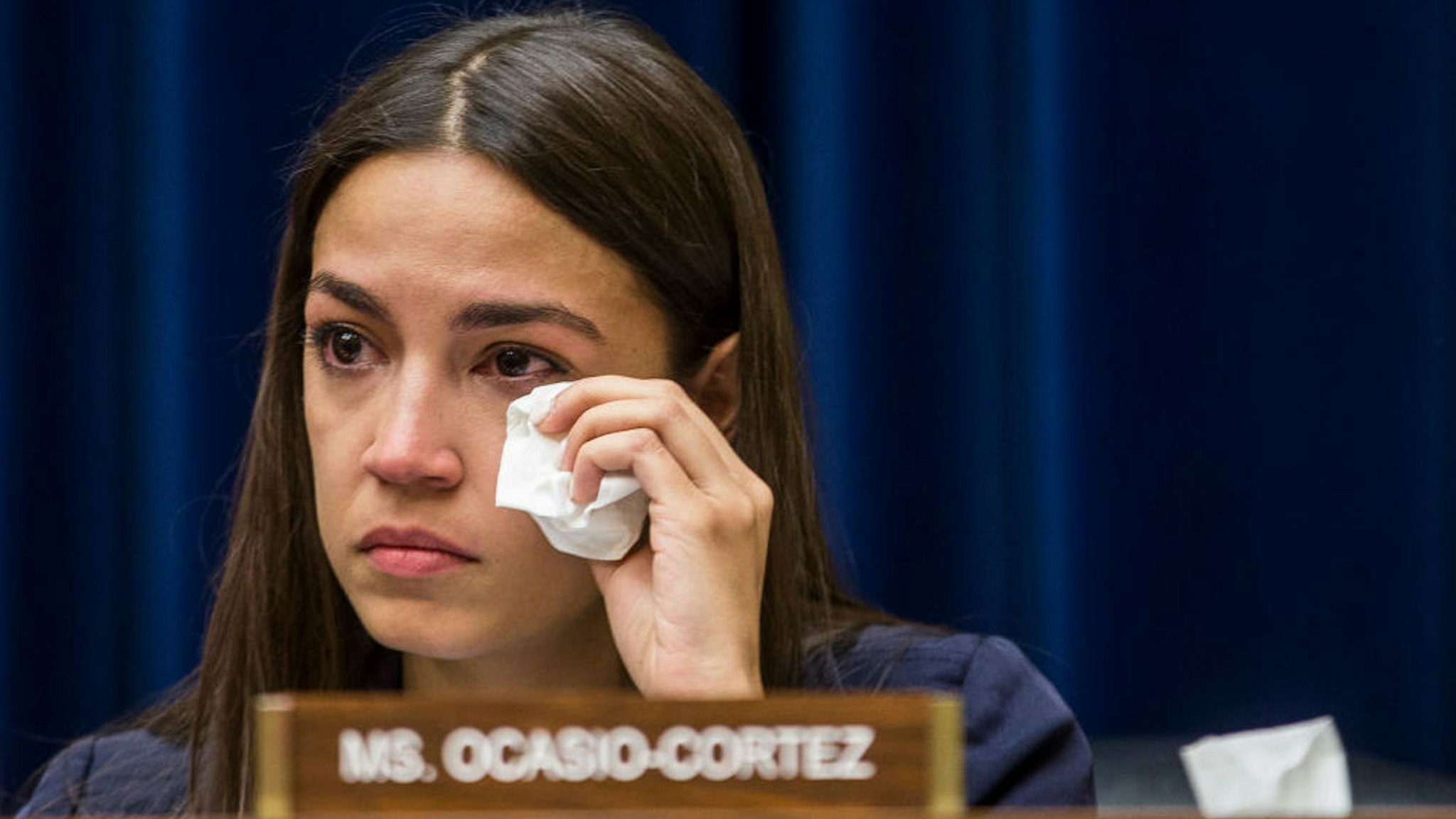 Rep. Alexandria Ocasio-Cortez (D-NY) wipes a tear during a House Oversight and Reform subcommittee on Civil Rights and Civil Liberties hearing discussing migrant detention centers' treatment of children on Capitol Hill on July 10, 2019 in Washington, DC.