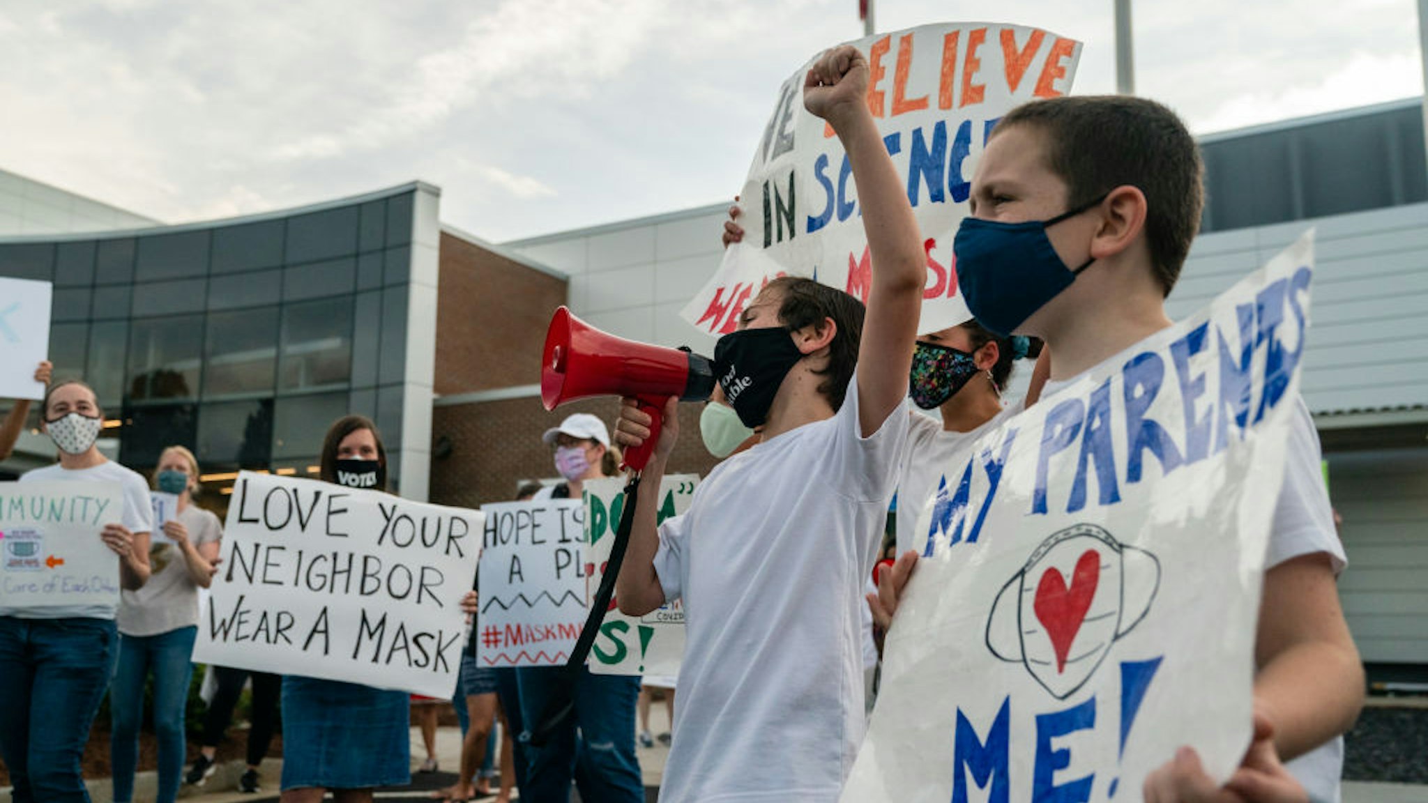 A pro-mask demonstrator with a megaphone speaks during a rally over Cobb School District's optional mask policy in Marietta, Georgia, U.S., on Thursday, Aug. 19, 2021. More than 200 doctors signed a letter asking the Cobb County School District to re-impose a mask mandate due to a surge in COVID-19 cases in the community, reported the Atlanta Journal-Constitution. Photographer: Elijah Nouvelage/Bloomberg via Getty Images